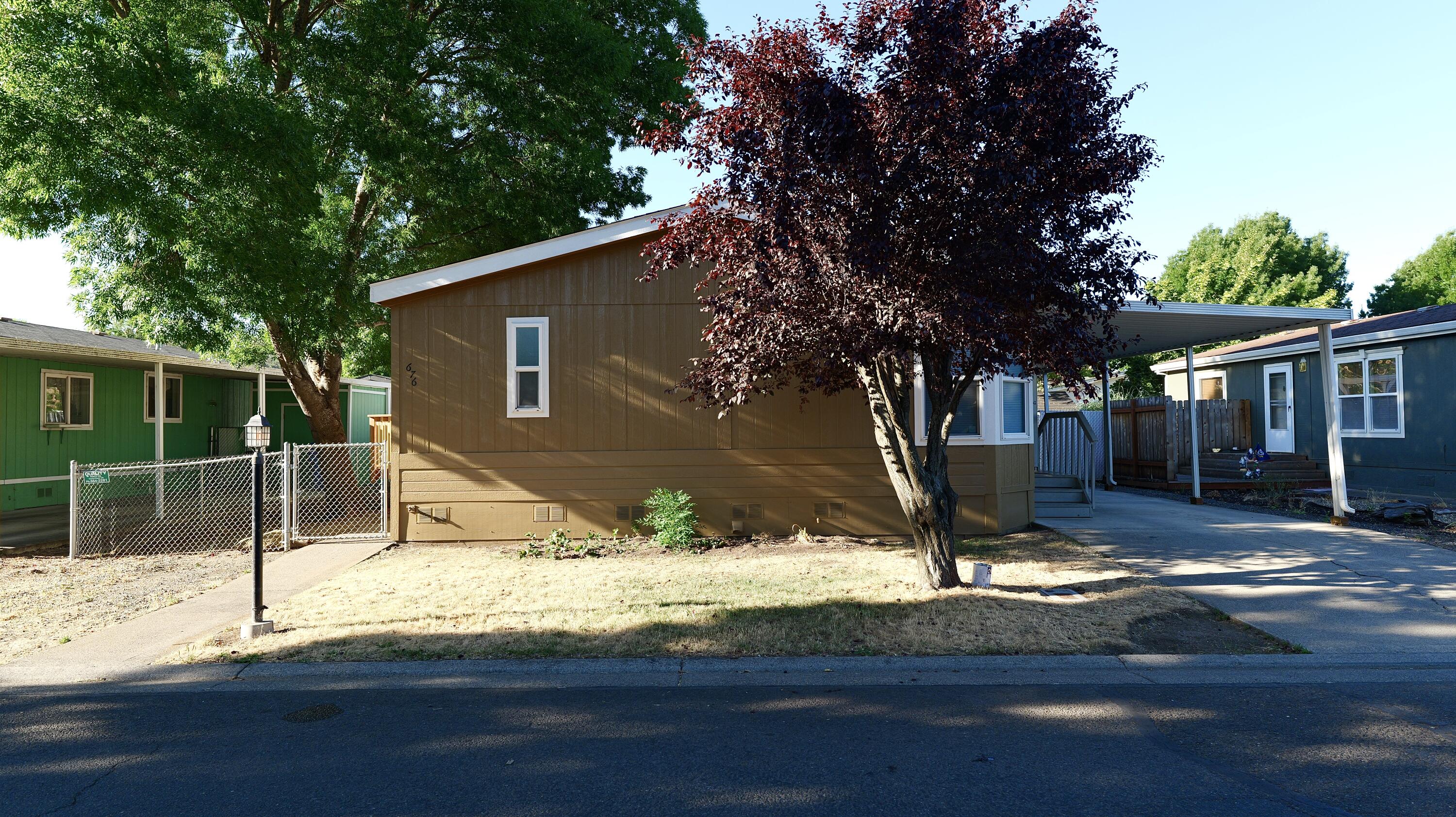Charming 3-bedroom, 2-bath home with 1,296 sq. ft. of comfortable living space. Featuring a light and airy open floor plan with brand new interior and exterior paint, all new flooring throughout and a spotless interior that's move-in ready. New roof 2024, fenced yard, carport with storage shed. Venture outside to a brand-new deck, landscaping and yard are a blank canvas for your personal touch. Conveniently located near shopping, schools, and a neighborhood park - this is a must tour!
