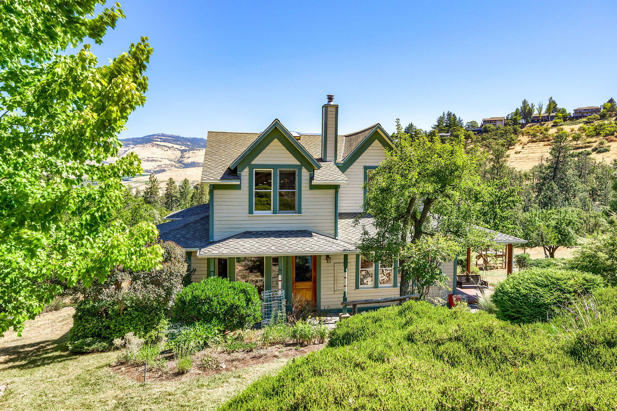 Unobstructed view of the valley & Grizzly Peak can be seen from this beautifully updated 4 bed + den, 2 bath 2500 sq ft, 1910 Arts & Crafts farmhouse. Nestled into a beautiful landscape bordered by seasonal creeks, enjoy the privacy of the country in this slice of paradise, close to downtown Ashland. The home is updated with high quality materials such as Brazilian cherry floors, double hung windows & Restoration Hardware lighting. A Vermont Castings wood stove adds coziness in winter while a new HVAC provides heating & cooling year round. The spacious eat-in kitchen opens onto a screened-in porch, overlooking a large meadow rimmed by mature fruit trees and a sunny fenced-in vegetable garden fed by an abundance of water with a strong well, a year-round spring, holding tanks and a computerized watering system. Across from the home is a charming 1 bed, 1 bath cottage, workshop and barn for storage. This is a must see home & property.