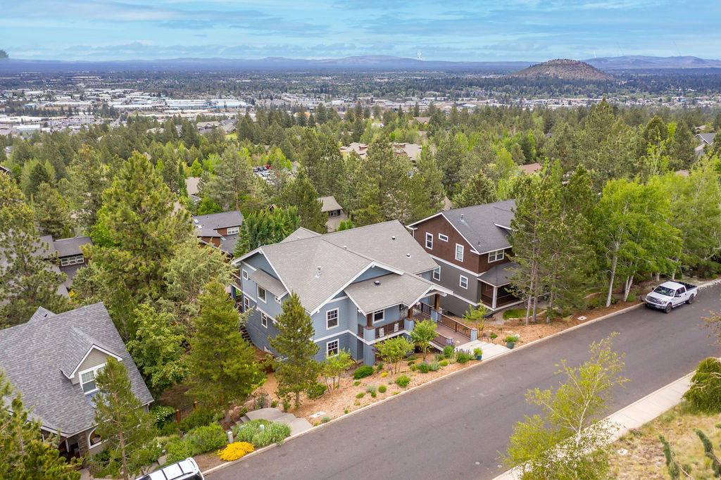 $145k price reduction!! Breathtaking panoramic Easterly views from the moment you step inside this tastefully updated home in Awbrey Village. Grand ceilings and windows capture Smith Rock and the city. Step out on the oversized decks, entertain friends with views of the 4th of July firework show from Pilot Butte, neighborhood block party! Main level living with master, office, kitchen, dining, 2nd bedroom and guest bathroom. Lower level featuring huge bonus room/flex space with wet bar, laundry, guest bathroom, 2 additional bedrooms. This level also features a separate entrance and deck if separate living quarters are desired.  Ample storage throughout! Gym room in the three-car garage. Completely fenced with electric gate to enclose the private backyard with raised irrigated garden beds. Close to everything Bend has to offer including river trails, parks, downtown, and shopping with easy access to Mt. Bachelor and the Cascade Lakes. Instant equity at this price!