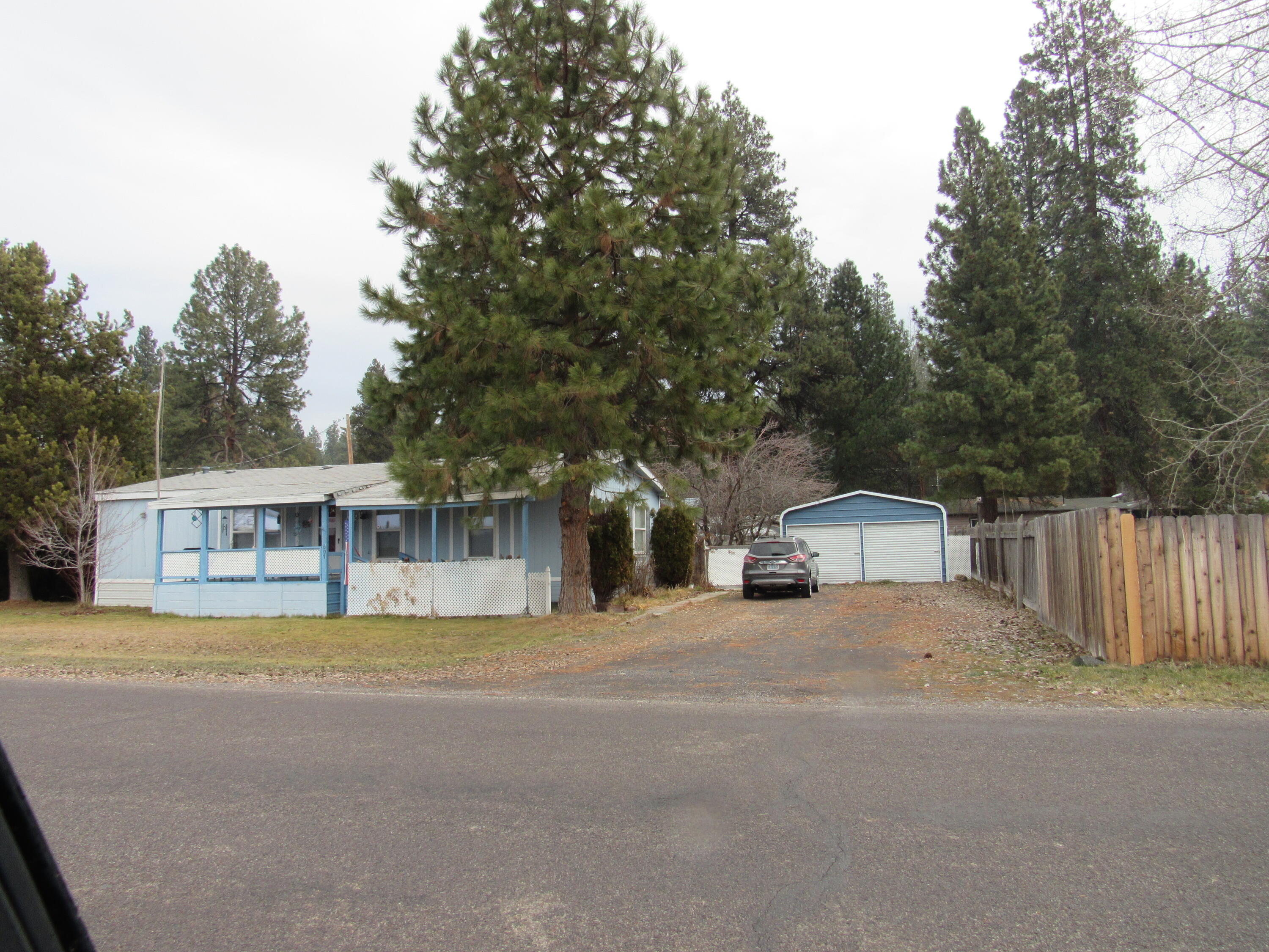 Well-maintained 1993 manufactured home offering 1,344 sq ft with 3 bedroom 2 full bath, situated on a .22-acre lot. The home features a certified wood stove for efficient heating along with large front and back deck ideal for outdoor living and entertaining.  The fully fenced backyard includes a small, manageable yard with fruit trees and a couple pines, perfect for pets, gardening or relaxing evenings. A detached 2 car garage provides excellent storage and parking. Conveniently located near Chiloquin Elementary and High School across from the Chiloquin Football field, and just minutes from the Williamson River and Sprague Rver, close to Crater Lake National Park offering easy access to fishing, recreation and outdoor actvities. Offered at $189,000 -- a great opportunity for a primary residence,  rental, or investment property.