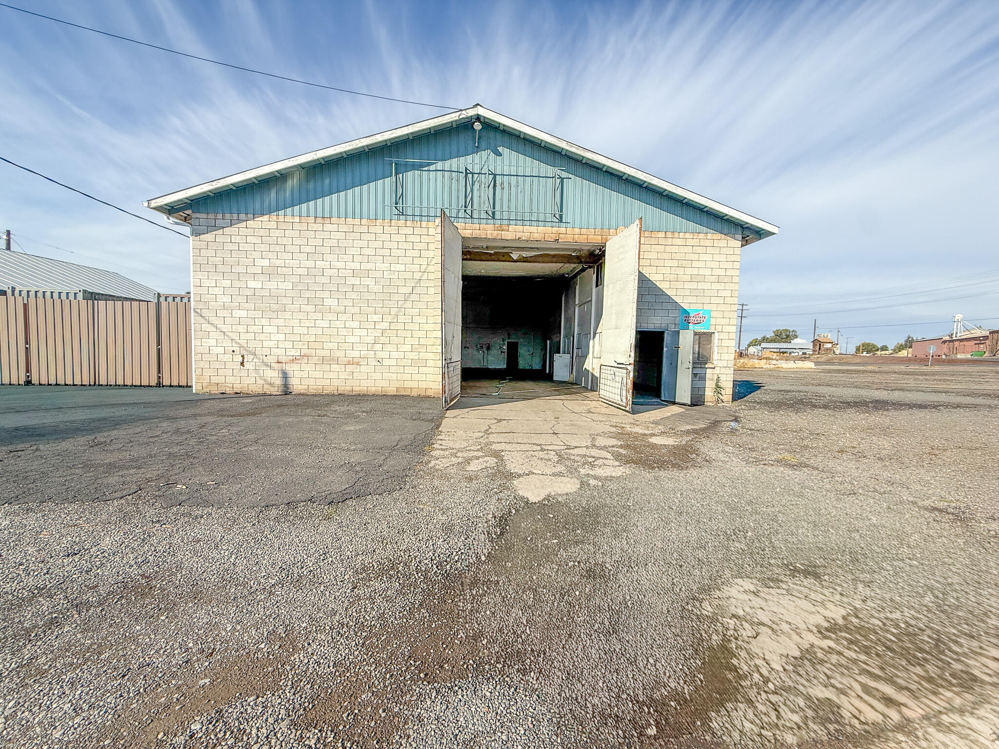 Prime turn-key commercial property in a high-traffic location, ready for your next venture! Situated on nearly ½ acre, this 3,000 sq. ft. block building with a durable metal roof, multiple roll up doors, office spaces and an upstairs parts room, offers endless potential. The space is well-equipped with 3-phase power, three overhead cranes, gas heat, and a large storage yard with ample parking. An adjacent lot is included, adding extra value and flexibility for expansion or outdoor operations.
Previously used as a mechanic's shop, car lot, and fabrication/manufacturing space, this versatile property is ideal for a wide range of commercial uses. With its excellent visibility, easy access, and solid infrastructure, this is a rare opportunity to own a fully functional commercial site in a prime Prineville location.