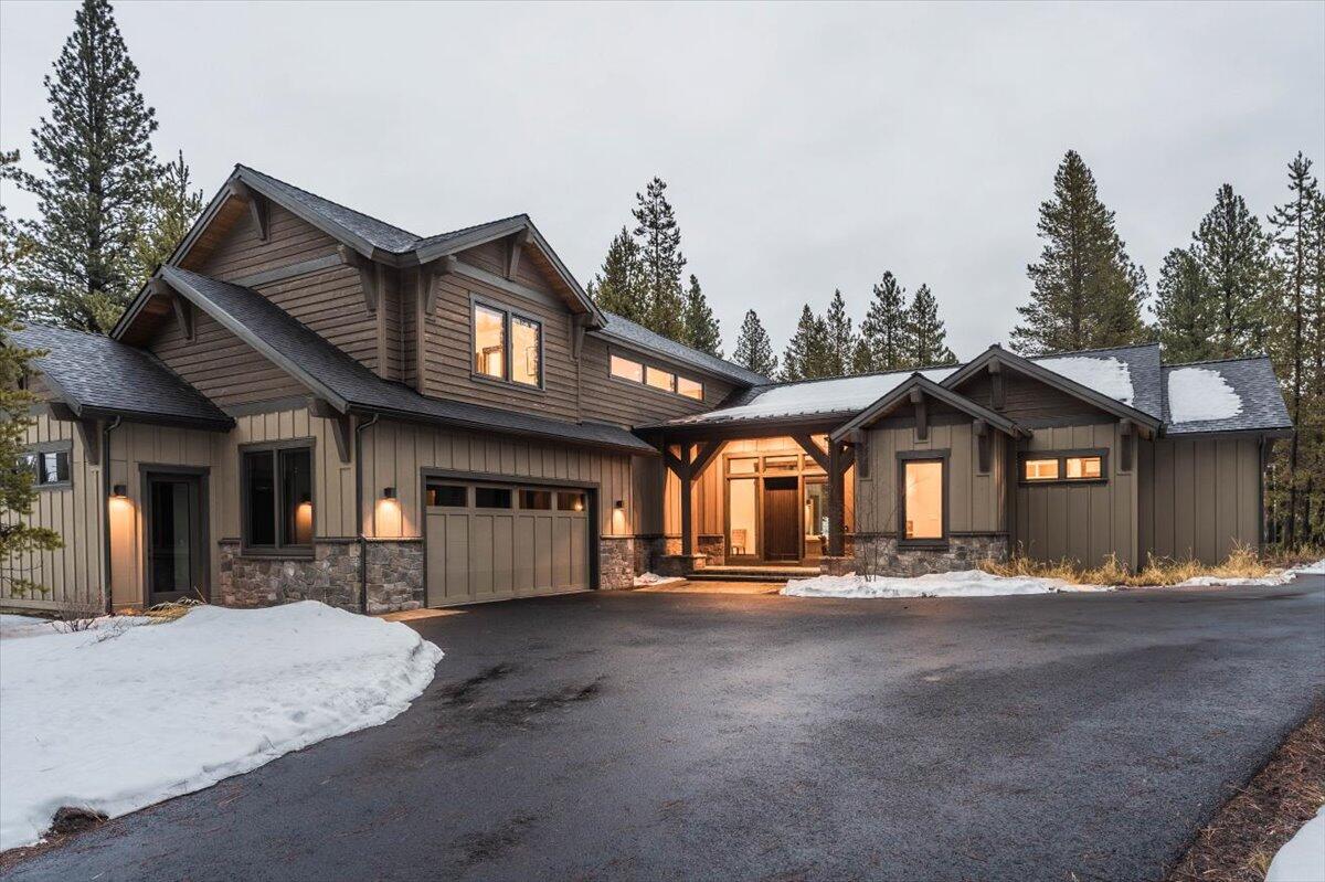 Welcome to the epitome of modern elegance & NW mountain charm! This nearly new home offers a perfect fusion of contemporary design & rustic styling. As you step inside, your gaze is immediately drawn to the beautiful covered courtyard featuring outdoor heaters & a built-in wall fireplace, an inviting space for enjoyment & entertaining. The interior includes a high-end furniture package. The spacious great room opens up to a chef's dream gourmet kitchen, equipped with Thermador stainless steel appliances, including 2 dishwashers & a walk-in pantry. Automatic blinds make it easy to let natural light stream in. The primary bedroom on the main level offers a luxurious spa-like bath. The second level is dedicated to comfort & functionality with 2 junior suites, including en-suites, a fun bunk room & a bonus room. For those who love indoor-outdoor living, the dining area is perfectly situated off the patio, creating a seamless flow for entertaining guests in a private forested setting.