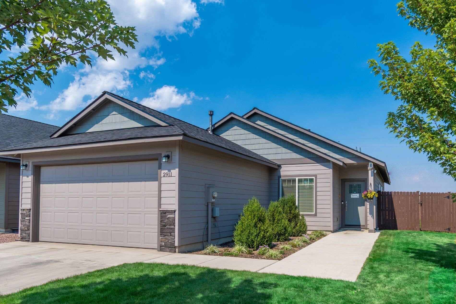 Immaculate 5-year old 3bed/2bath single-level in a quiet, newer 55+ community in NW Redmond with the lowest HOA dues in town. Set on a private corner lot with 3 sides of privacy (1 of only 4 in nbrhd) this nearly new home shines with pride of ownership. LVP floors flow through the main living areas: vaulted living room features mantled gas fireplace, the kitchen offers quartz counters, rich stained cabinetry, stainless steel appliances, and a dining area large enough for a table of 6 plus extra counter seating. Extra large primary suite offers coffered ceiling, serene outlook, and double sink bath w/ tile accents and rain-glass shower. Two more bedrooms, hall bath for guests, and laundry with sink and BONUS incl. w/d. 2-car garage, fully fenced yard with sprinklers, newly stained fencing, and patio. One of the nicest usable yards in the community-great for pets, entertaining or grandkids. Enjoy Cascade views, sunsets, and a convenient canal walking trail 100 yards away.