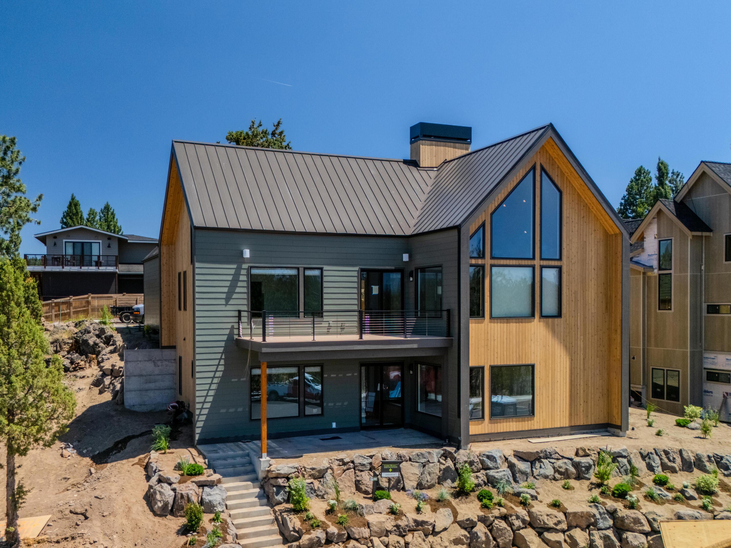 Introducing Talline Lot 34 - an architectural standout and the official COBA Tour of Homes Showcase Home for 2025. This striking modern residence is a celebration of clean lines, intentional design, and Scandinavian-inspired elegance, making it one of the most anticipated homes of the year.

With an innovative L-shaped footprint, this two-level home offers a layout that is both functional and refined. The home features 4 bedrooms and 3.5 bathrooms, thoughtfully distributed across both floors to accommodate comfort, privacy, and flexibility. The main level includes an open-concept great room, spacious kitchen, and primary suite, all seamlessly connected to outdoor living spaces, including a generous patio. On the second level, you'll find additional bedrooms and a secondary bonus room that opens to a private upper-level deck - perfect for elevated relaxation or entertaining