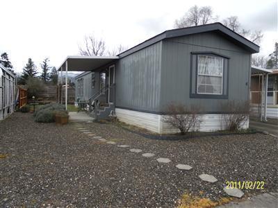 Motivated Seller! 2 bdrm, 2 bath home located in Greenway Village a 55+ community. Split floor plan with vaulted ceilings, ceiling fans, textured walls. Newer cook top, wall oven, counter tops, faucets, sinks and interior paint. Also included new washer & dryer, refrigerator. All furnishings can also stay except TV & TV components. Easy care yard, storage shed, covered carport, new electric lawn mower. Space rent $330/mo includes water, garbage & sewer. Conveniently located between Phoenix & Talent.