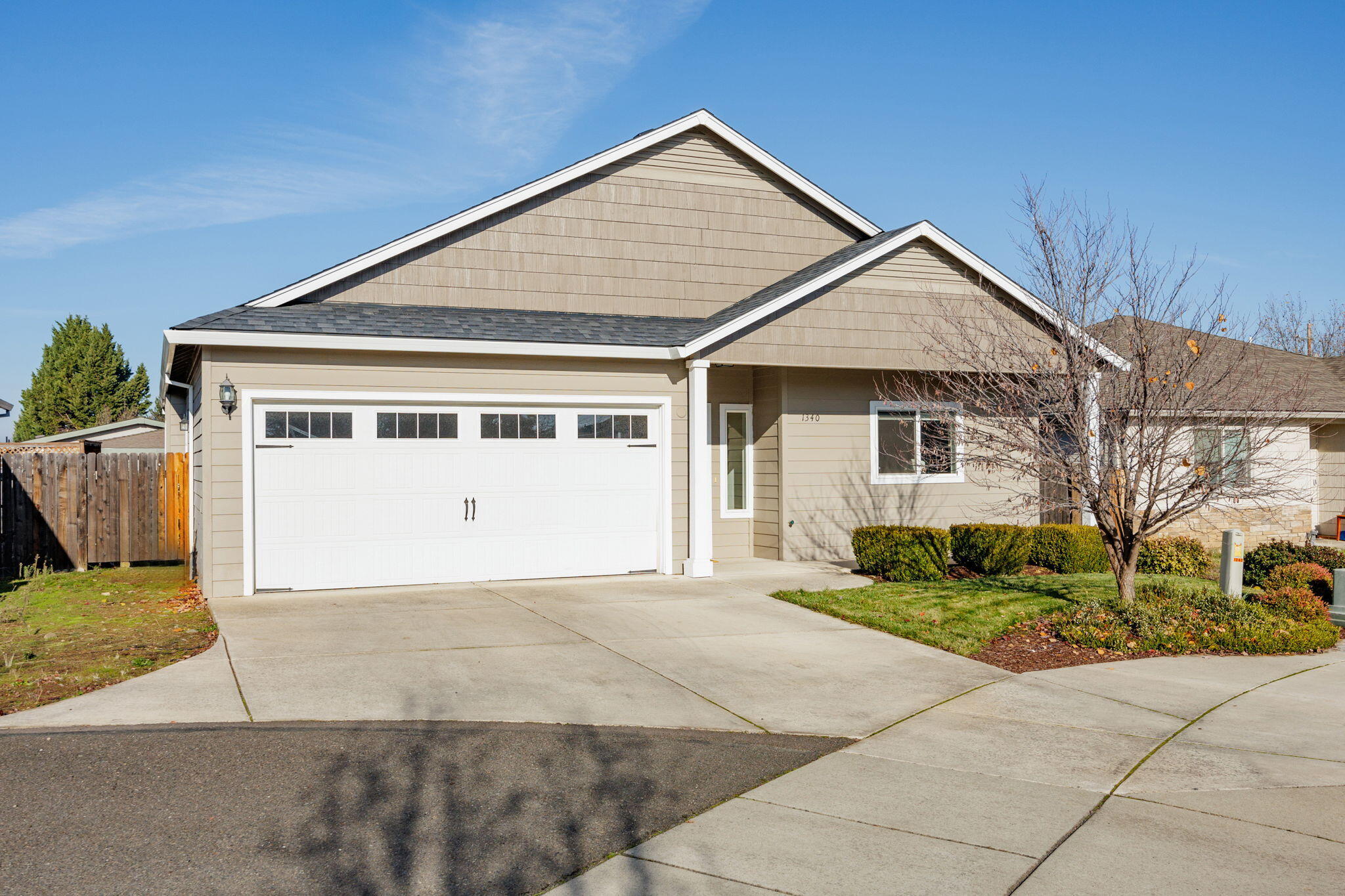 Recently updated Southwest Medford! This 3 bedroom 2 bathroom home is fully fenced, landscaped and turn key inside and out. Updated interior paint and flooring was just completed. The open concept and vaulted ceilings make this house great for entertaining. Spacious kitchen with oversized island and tons of storage, beautiful granite counter tops and a brand new induction stove/oven. Large master bedroom with engineered hardwood floors and a big walk in closet. Covered back patio and pleasant back yard.  Located in a quiet neighborhood cul-de-sac. Home feels as good as new!