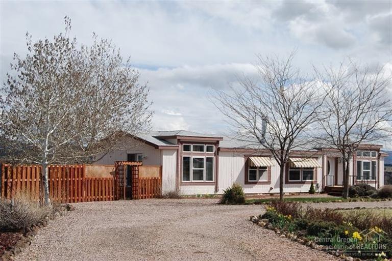 Stunning Rim Setting w/views form Smith Rock & CRR Golf Course up the Crooked River Canyon to the green farm-fields above the canyon walls & majestic Mt. Hood in the background. Such a serene setting! Tastefully landscaped w/wrap around decks. Bright great room w/floor to ceiling windows, wood burning fireplace in living, French doors to private courtyard & spa. Laminate/tile flooring. Gourmet kitchen with island/breakfast bar & utility has oodles of pantry/storage. It's a charmer!