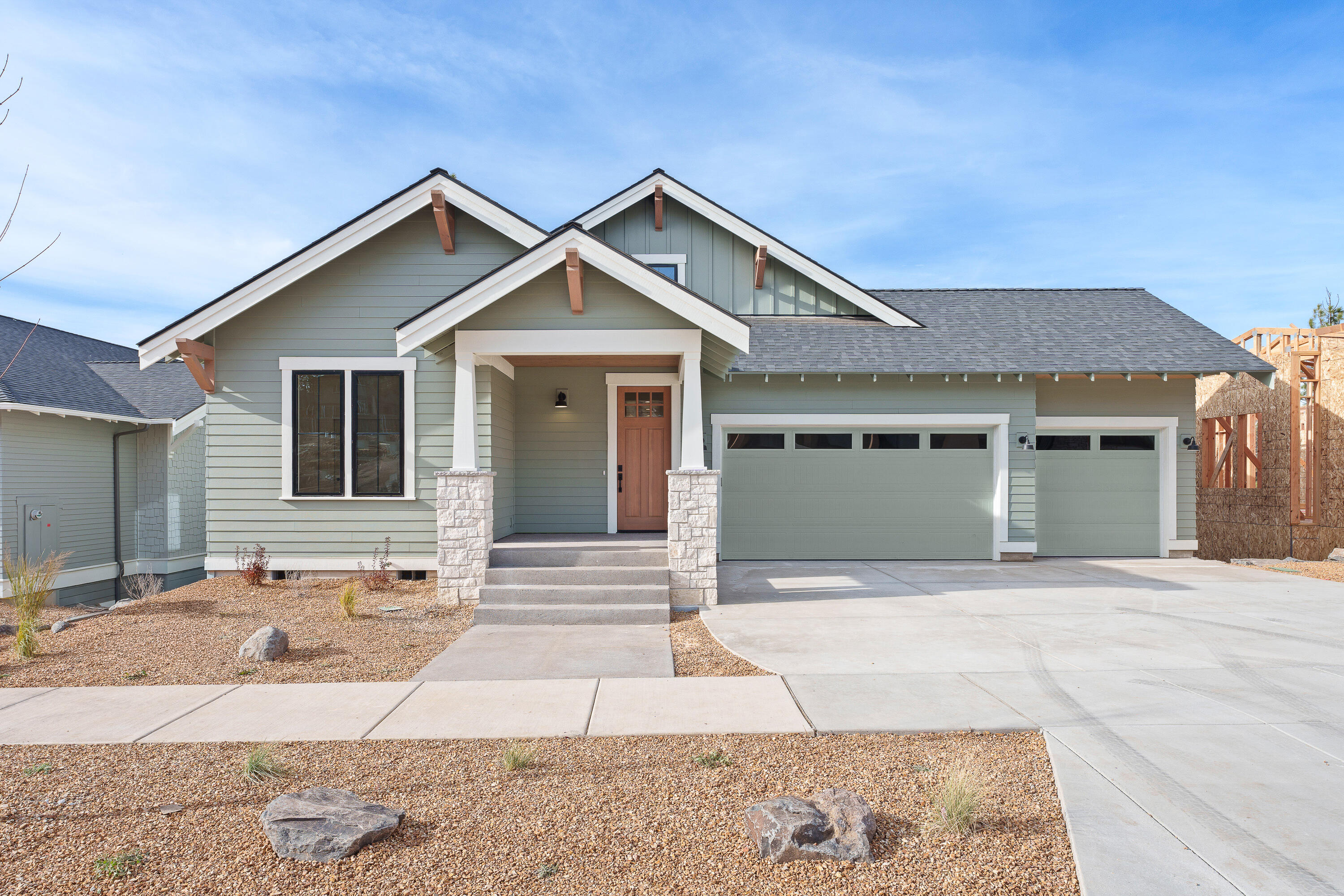Welcome to this meticulously designed 5-bedroom, 3-bathroom home in the coveted Talline neighborhood. Offering 3,207 square feet of luxurious living space, this two-story residence harmonizes modern design with mountain town charm. The main level is the heart of the home, featuring an expansive open-concept living room with high ceilings and abundant natural light, seamlessly connected to the kitchen and dining area. The kitchen is outfitted with high-end appliances, an island, and plenty of space for preparing meals and gathering with family. Step outside onto the spacious porch, ideal for outdoor entertaining or enjoying the fresh Bend air. The main floor also features a serene primary suite with a luxurious ensuite bath, walk-in closet, and built-in storage. Additionally, two guest bedrooms and a full bath, plus a laundry room, make this floor functional for daily living. Upstairs, the bonus room offers a versatile space for a home theater, game room, or lounge.