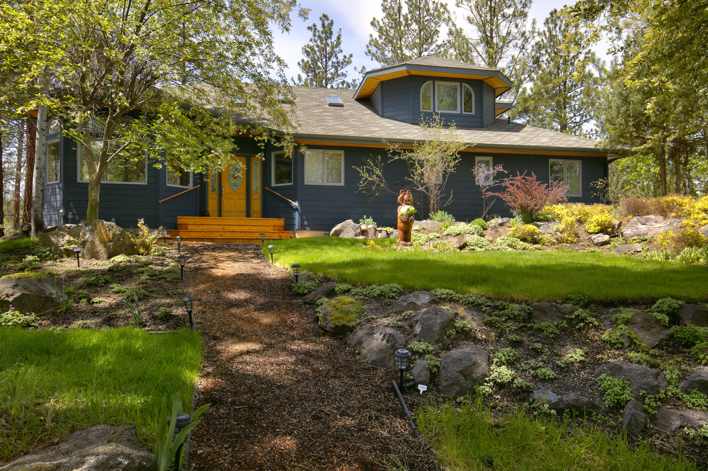 The lifestyle of Bend is wrapped up in this home beautifully situated on secluded 9.34 acres. Only 1 mile away from Shelvin Park and 10 minutes to downtown and Bend's activities. A paved driveway winds to the home's attractive landscape adding serenity to this well-cared for home. Upon entering, natural lighting is captured through the windows that overlook picturesque views of treetops, the ridgeline and canyon within the property. High-end fixtures and finishes are featured in the updated kitchen and primary jaw-dropping bath. Enjoy in-floor radiant heating throughout the home.  2 additional bedrooms are situated on the main level along with a utility room with ample storage.  The oversized 2 car garage has a workbench and excess storage - perfect for tuning bikes or waxing skis.  Year-round entertaining possibilities are endless. Enjoy lunch al fresco and soak up the sun on the spacious deck. This fantastic property is uniquely secluded yet adjacent to the Saddleback neighborhood.