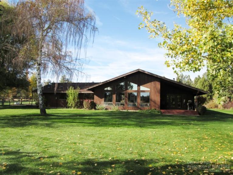 Private serene country home,minutes to downtown Redmond.Pass through the automated gate entrance onto the 1.9 acres,enter your own private retreat.Fully fenced & cross fenced pasture w/automated sprinkler system.27x30 Barn w/two covered stalls plus tack room & roll up door.The 35x40 shop W/abundance of storage w/two interior rooms,large workbench & 12 ft roll up doors on both ends.The 4 bedroom 2 bath 2,300 sf home features vaulted ceilings w/plenty of windows to bring in the park like setting.
