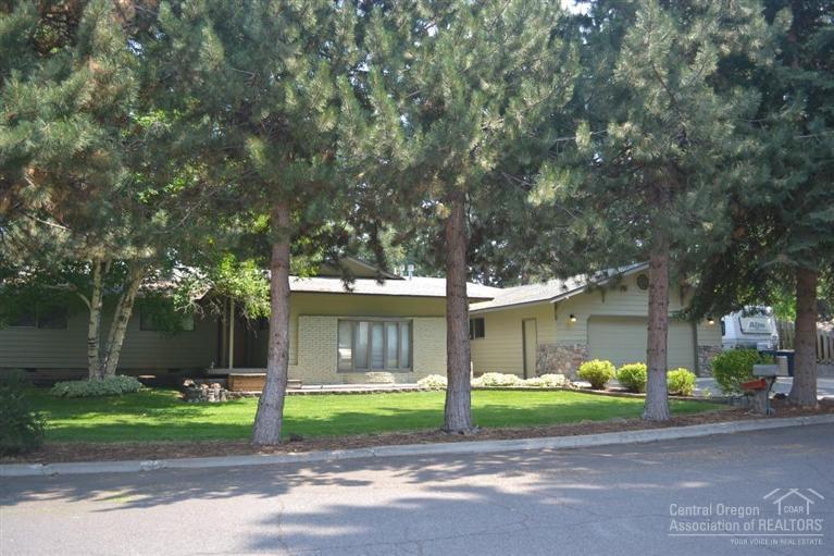 Great location, large single level home in established family neighborhood. Extensively updated home w/large kitchen, newer cabinets & appliances. Family room with slate floor & gas stove. Sunken living room has rock hearth & wood mantle with a fire place. Hot tub room off of master. Home features ceiling fans, walk-in closet, 4 bedrooms & an office, recessed lighting, skylights, laundry room. This home sits on a large beautifully landscaped fenced lot w/a green house. The heated garage/shop has 1400 Sq.ft.