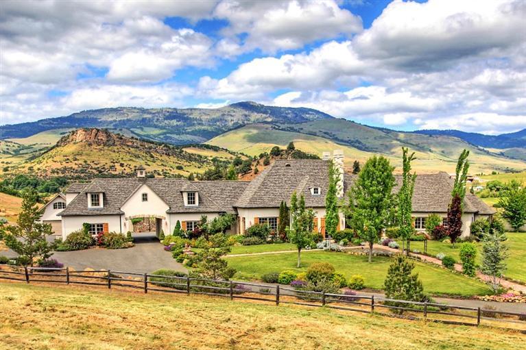 This astonishing French Country Estate lies on the dynamic rolling hills with panoramic views. Located minuets from town of Ashland Oregon, the home of Oregon Shakespeare Festival, also The Top 10 Most Desirable Small Town To Live in US''. The south-facing hillside is ideal for a boutique vineyard or horseback riding. As you entering, a custom designed patina finished gate welcomes to a paved driveway. The 5804 SF with 5 Beds and 5 2/1 Baths home features; Chef's Dream Kitchen, Luxurious Master suite, Library & Theater and attached but separated 690 SF Guest Quarters. Plaster walls with stone accent, pine and stone floors. Beautiful French Country details with brick accent through out. A Charming brick patio with climbing rose trellis opens to a lagoon style salt-water swimming pool with a beach entry. Enjoy entertainment or just sit back with view of iconic Pompadour Bluff. Seasonal creek & pond.