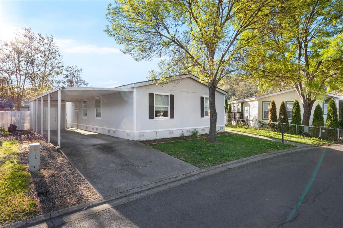 Jump On this opportunity!  Back On Market at no  fault of  home!!  Own one of the nicest lay-outs and largest homes in desirable Butte Crest Mobile Home Park! Enjoy peace of mind with a new roof that was installed in 2022  and a new heat pump installed in 2019.
There is also brand new carpeting!  The spacious kitchen features abundant cabinetry, subway tile, and striking epoxy resin counter-tops. The primary suite offers a refinished shower and updated resin vanity. A large office could easily serve as a 4th bedroom. Custom high-end fabric blinds throughout add a stylish touch. Outside, enjoy a beautifully landscaped yard with custom built raised garden beds, a freshly stained deck, and a unique in-ground  kiddie or doggie splash pool. Move-in ready and full of charm!  Plus all appliances are included!