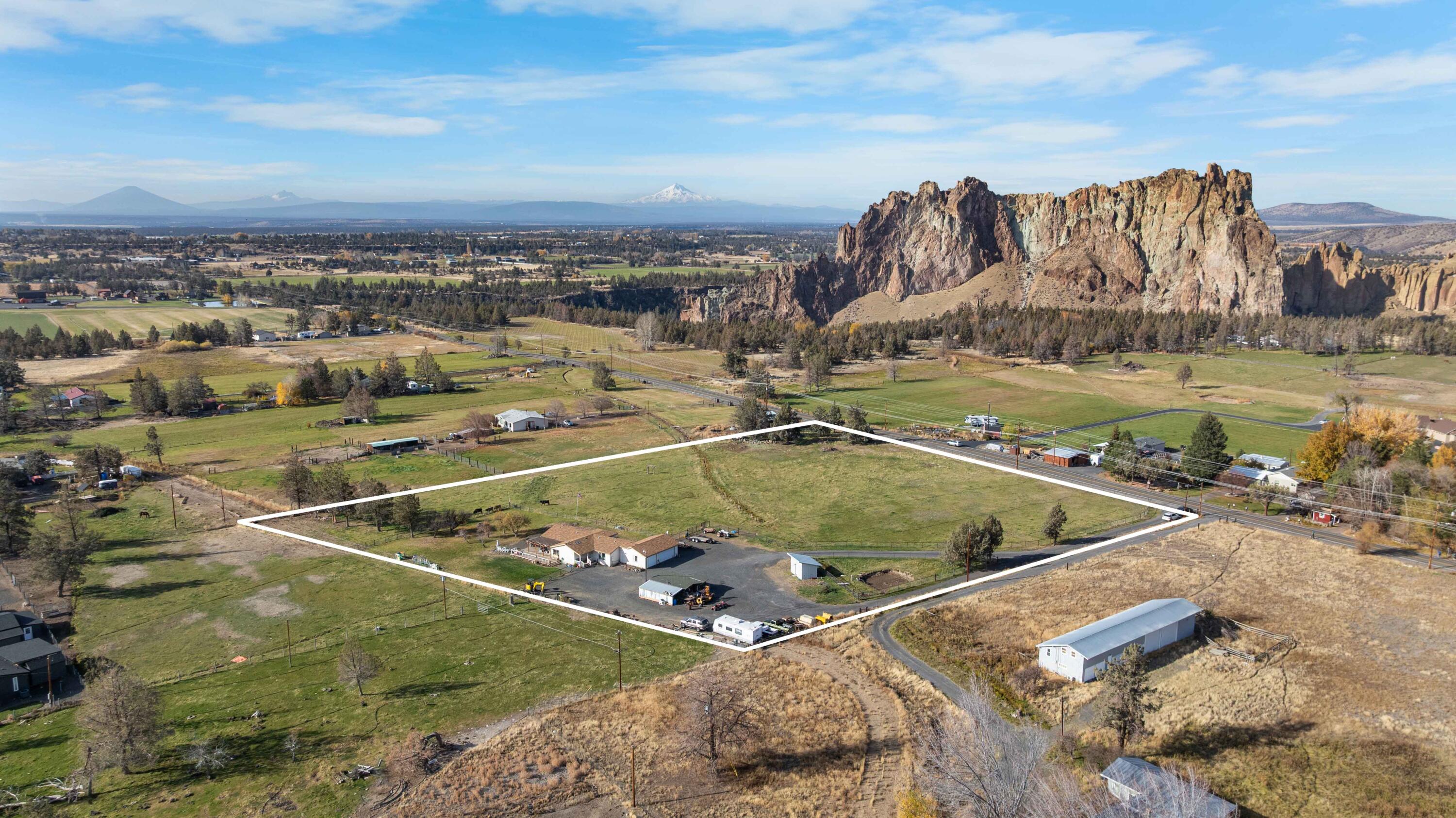 Enjoy breathtaking, unobstructed views of iconic Smith Rock State Park from this well-cared-for 3-bedroom, 2-bath home set on 4.86 acres with 4.5 acres of COI irrigation. The property has seen several important updates, including a new well, HVAC system, driveway, and full metal perimeter fencing, providing a strong foundation for future improvements. Inside, the home offers a bright, inviting layout with a spacious kitchen, comfortable living areas, and an office/den ideal for remote work, hobbies, or a quiet retreat. Large windows are positioned to capture the surrounding natural beauty and stunning rock formations.The land is fully fenced and landscaped for easy living, blending Central Oregon's rural charm with everyday convenience. Located just minutes from world-class hiking, climbing, and outdoor recreation at Smith Rock, this property offers incredible views, space, and potential in a truly special setting.
