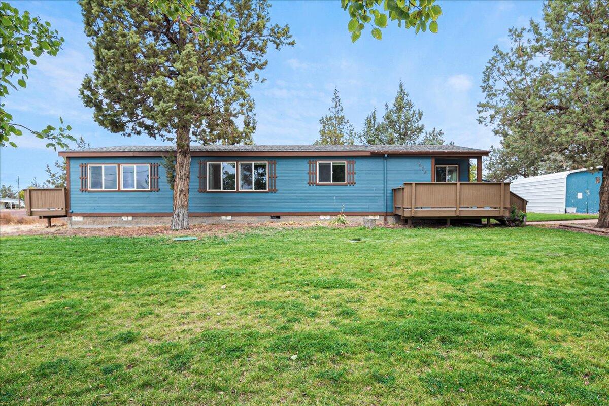 Craving the quiet of country living without giving up convenience? Welcome home to this beautifully maintained 2-bed, 2-bath gem in the heart of Terrebonne. Step into a spacious great room with gleaming tile floors, a cozy wood stove, and oversized windows that flood the space with natural light. The bright and cheery kitchen features granite countertops, a stone backsplash, and sleek black appliances—plus a dining area with a built-in china cabinet. The oversized primary suite feels like a retreat with its private deck access, jetted tub, separate shower, and generous storage. A large laundry/mudroom adds everyday ease with even more storage and direct access to the backyard & back deck. Set on a fully fenced, .32-acre lot, this home has room to play, plant, and park—with underground sprinklers, RV hookups, and a brand-new septic system (2023) Cascade Views too!!
