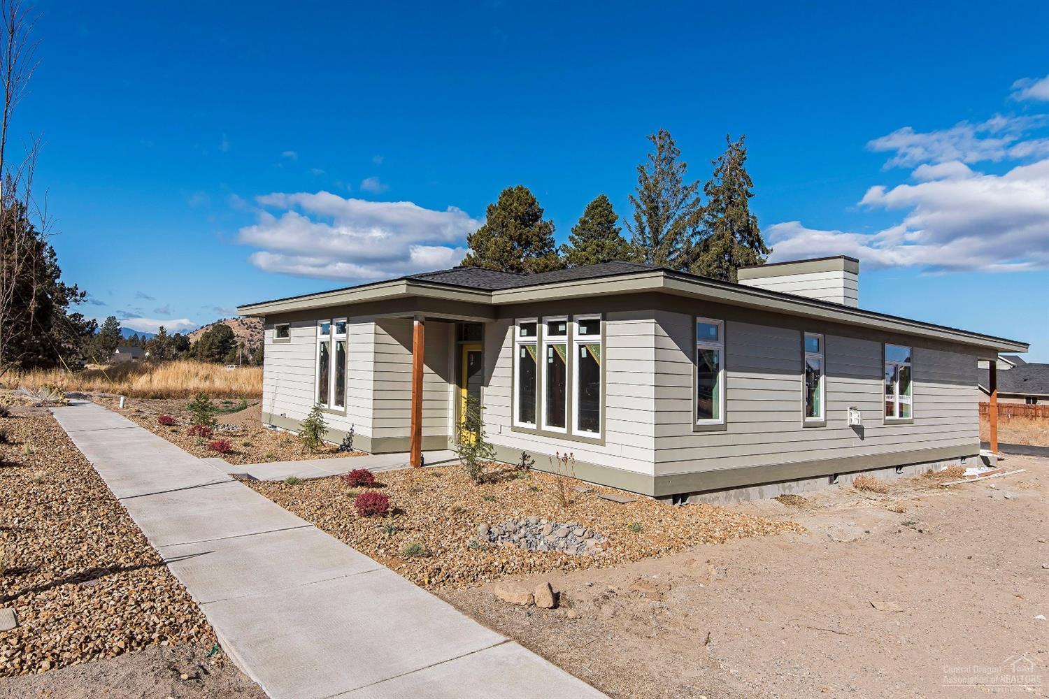 Come see this single story mid-century modern home featuring a great room floor plan with gas fireplace separating the dining and living areas, extensive laminate wood floors, tile and solid surface counters. Nice location near shopping, parks and schools.