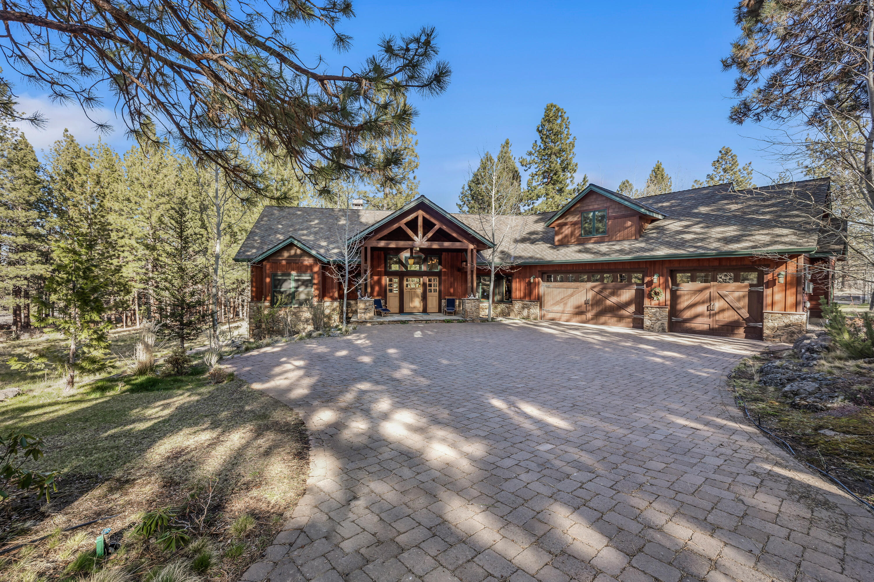Impeccably designed custom Northwest Lodge home on a private 9.88 acres, just minutes from downtown Bend. Soaring beamed ceilings provide an expansive feeling to the living room with its gracious stone fireplace and twisted juniper mantel. On the main level find 2 guest bedrooms with ensuite baths, study with built-ins, and a generous primary suite. Primary suite offers a cozy gas fireplace, custom walk-in closet, jetted tub and walk-in tiled shower and radiant floors. Upstairs discover a bonus room (art studio, office, guest suite?) with private bath. Outside enjoy multiple decks to sit and watch the wildlife. The property includes a 3 car garage, solar panels, lavender field and orchard, an insulated 20 X 40 shop and over 5 acres of irrigation. On a quiet country road, find your oasis 6 miles to services, schools, grocery and more.
