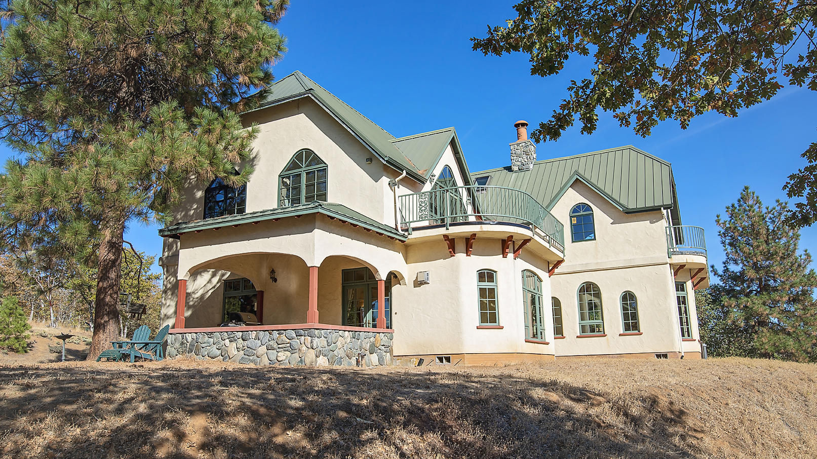 Welcome to the secluded serenity of the Ivan Lund 34 Acre retreat and only 3 minutes from downtown Historic Jacksonville. Ivan's vision and dream came together in the very custom one of a kind build.Beautiful, modern Tudor style home nestled in the hills of Jacksonville. This classic home features elegant craftsmanship and pride throughout. Stunning custom woodwork, heated main and upper level floors, gorgeous rounded archways and extraordinary custom windows throughout will give you a warm and inviting feeling from the moment you walk through the front door. This spacious home features 4 bedrooms, 4.5 bathrooms amongst 4628 sq ft, as well as a large 2 car garage w/shop and yoga studio to fulfill all your hobby, exercise and/or storage needs. The acreage is home to abundant wildlife and a seasonal pond. Very large indoor RV garage/ steel shop at the front gate of the property. This home is truly a stunning, one-of-a-kind build!