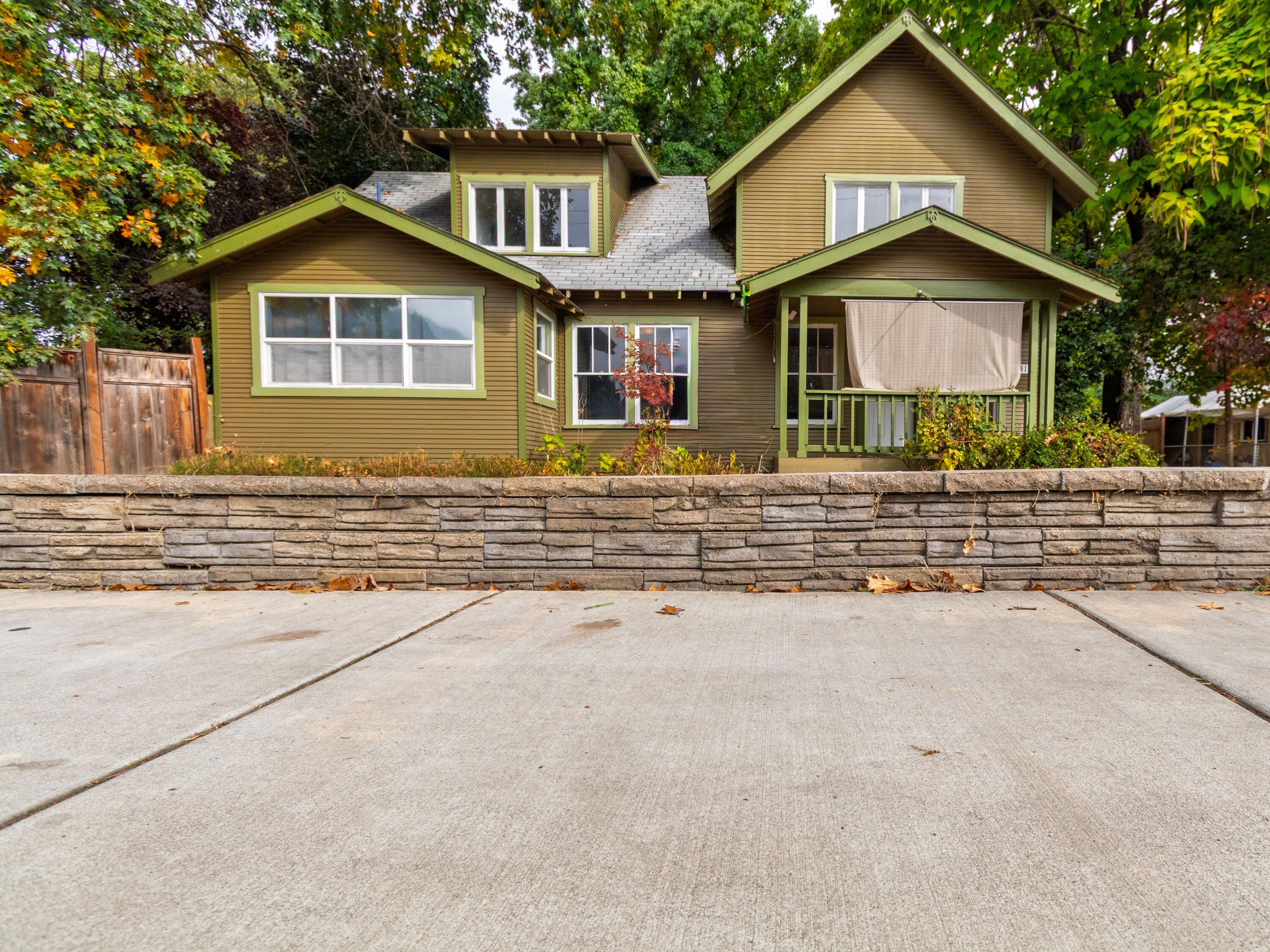 Discover this solid, well-built home full of timeless charm, ideally situated in the heart of Rogue River. Zoned commercial, this unique property backs to Wards Creek and includes a beautiful barn with plumbing already installed—offering great potential for an ADU. Also features a workshop and multiple carports with additional storage. Buyer to complete due diligence with the City of Rogue River.