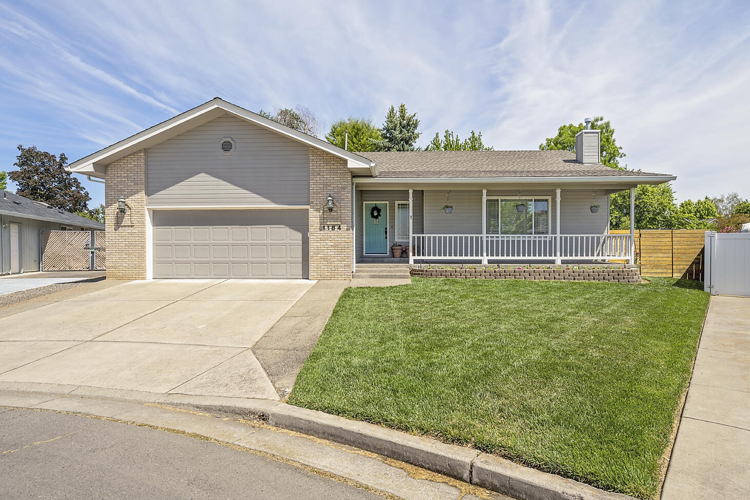 This crisp and clean East Medford home is located in a great cul-de-sac location and has been lovingly improved and maintained over the last several years. From the remodeled kitchen and bathrooms, to the well-kept, large fenced yard, there is nothing left to do but move in! You'll love the high ceilings, the quartz countertops, the two large living spaces, the cozy gas fireplace, and the spacious shower in the master bathroom. Everyone will enjoy time outdoors on the charming front porch, the covered patio, the open grass area and tending the garden boxes with raspberry plants. There is plenty of room for storage in the backyard shed, the built-in garage storage and the large laundry room. This is a fantastic home! Don't let this one slip away!