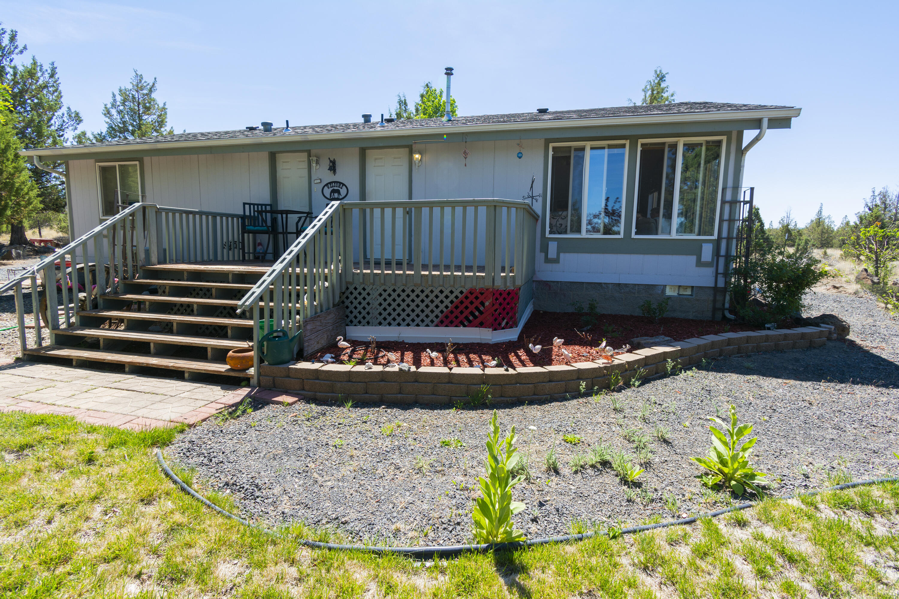 New Price: $319,900. !!!SELLER IS MOTIVATED!!! Welcome Home! Airy and bright, this cute  2 bed/2 bath 1100 sq ft manufactured on 1.7 acres is looking for a new family!  The property is fenced and cross-fenced. Plenty of room for your horses and all your toys. Sliding door from dining area leads to your deck (deck is not attached to mfg home) and your patio area done in pavers. Enjoy family barbecues on your patio or just sit in your hot tub!  Landscaped front and back. Certified Pellet stove . Garden tub and shower in primary bath. RV parking with water and electric. New roof in 2019 New well pump and casing in 2014. Pump house rebuilt in 2020. 24 x30 shop/garage, storage shed.   Call your favorite realtor today and make an appt to see this property!