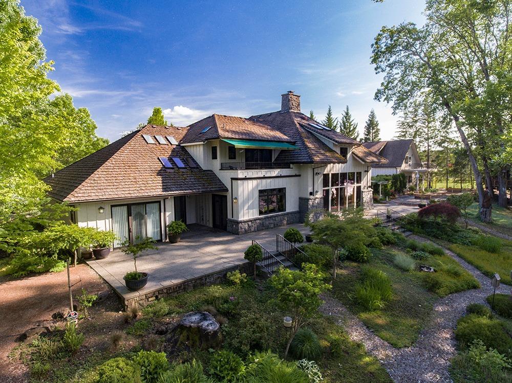 Impeccable custom home with Rogue River frontage! This gated and private estate home and property are located just outside the city limits but feels worlds away. The kitchen features the finest in appliances and is a cook's dream with granite counters and top of the line cabinetry and features galore! The living room and it's massive rock fireplace is the exclamation point on a already perfect property. The master suite is downstairs and private from the other ensuite bedrooms and there are extra bedrooms and a loft overlooking the living room and river as well as a small kitchenette and library sitting area upstairs. Two car attached garage with shop space as well as the oversized detached 2 car garage/shop with playroom/guest house above. The famous tree house sits on the river and is a great hideout for the kids! Horseshoes, pond, greenhouse and gently sloping river frontage complete the perfect riverfront living! Builder has $3.1 million into the property, per builder.