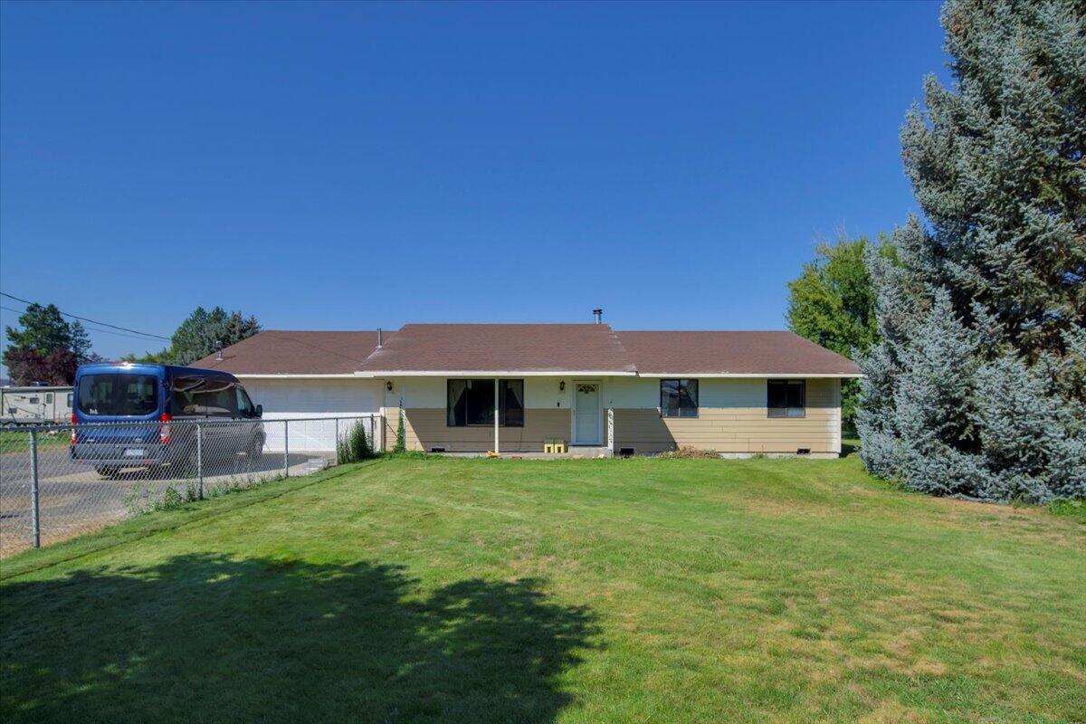 This lovely 1.12-acre irrigated property is close to town and ready for its new owner! Featuring 3 bedrooms, 2 bathrooms, and 1,830 sq. ft. of living space, there's plenty of room inside and out. Enjoy the covered back patio, oversized workshop with RV and boat storage, mature fruit trees, and lush green lawn. This property will not disappoint!