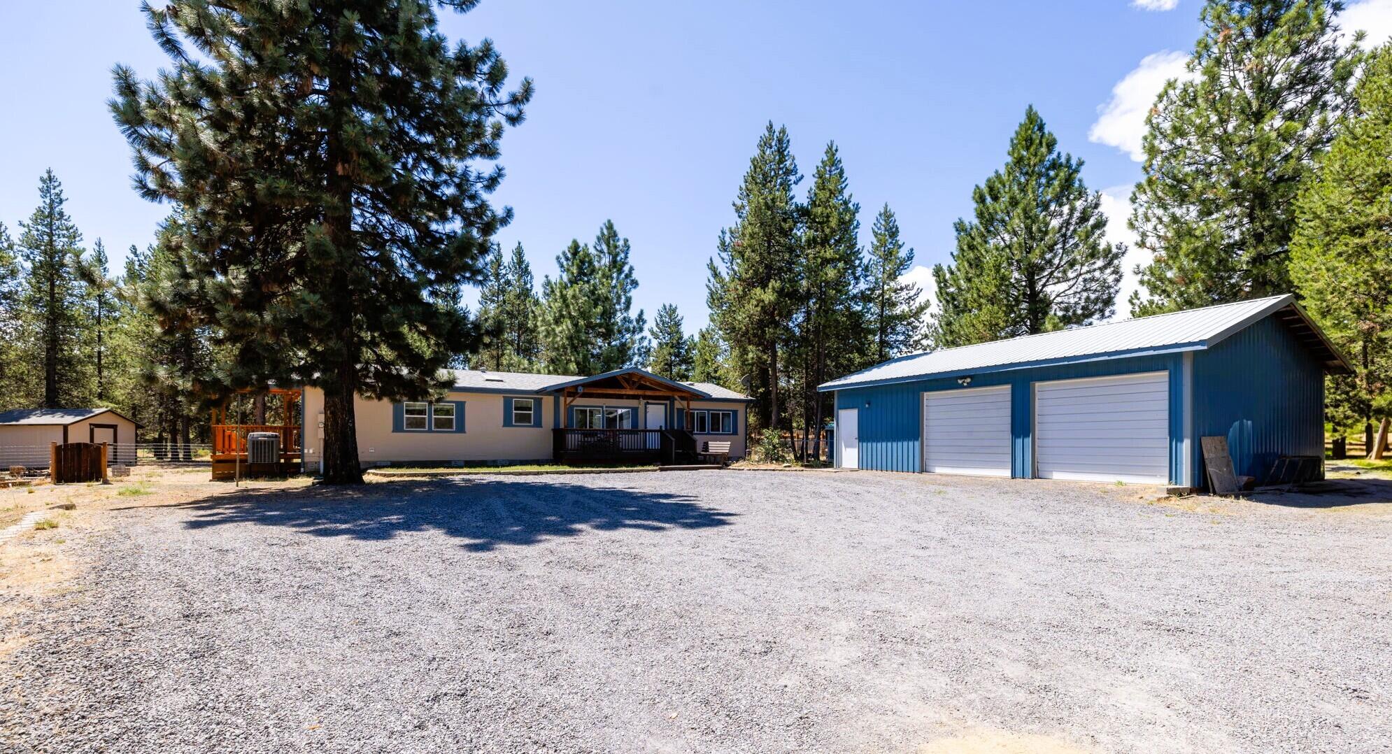 Special financing available with preferred lender - rates as low as 4.25%.
Enjoy peaceful living on this private 1-acre property just two minutes from La Pine State Park. This well-maintained 3-bed, 2-bath, 1,566 sq ft home offers space, privacy, and thoughtful updates including a newer roof, fresh exterior paint, and rebuilt front, back, and ramp-access decks. Inside, vaulted ceilings and a cozy fireplace create a warm, inviting feel. The kitchen features skylights, an island, walk-in pantry, and adjacent laundry room. The spacious primary suite includes a walk-in closet, dual sinks, and soaking tub. A heat pump provides efficient year-round heating and cooling. Outside, enjoy fenced front and back yards, a large dog kennel, RV parking, a two-bay garage with workshop, plus a 12x12 storage shed and woodshed. Convenient access to Hwy 97, Bend, Mt. Bachelor, and outdoor recreation.