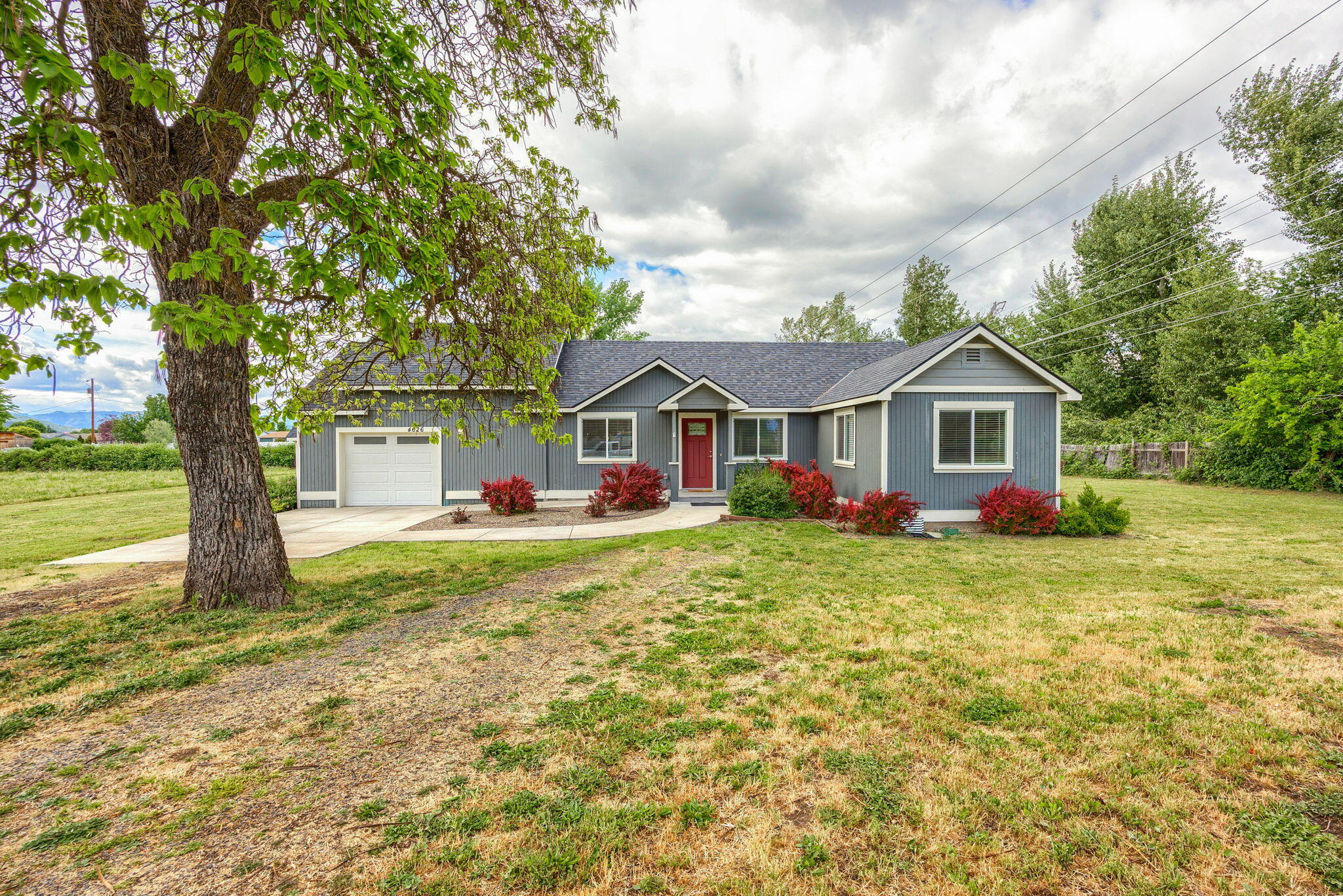 Fantastic remodeled home with a great country setting, yet close to town. This home & property offer 2.9 flat, usable acres and is in the city of Central Point. Home features 3 bedrooms, 2 full bathrooms, approx. 1157 sq ft, separate utility/laundry room and abundant natural lighting, attached one car garage. small barn/shed and irrigation rights. Remodeled in 2020/2021 down to the studs and offers all new kitchen with
range/oven, dishwasher & garbage disposal, 2 bathrooms with tub/shower combos, exterior siding, composite deck, flooring, vinyl windows, roof, cabinetry, lighting, fixtures, doors, trim & more. Backyard offers a deck, small barn/shed. Home sits towards the back of the property and near the creek. Irrigation rights & creek frontage: one tax lot is 1.3 acres w/the home & barn/shed & the other is land only with 1.6 acres. Buyer to do their own due diligence regarding the use of the property. Located near schools & the Central Point arboretum. RV parking & more.