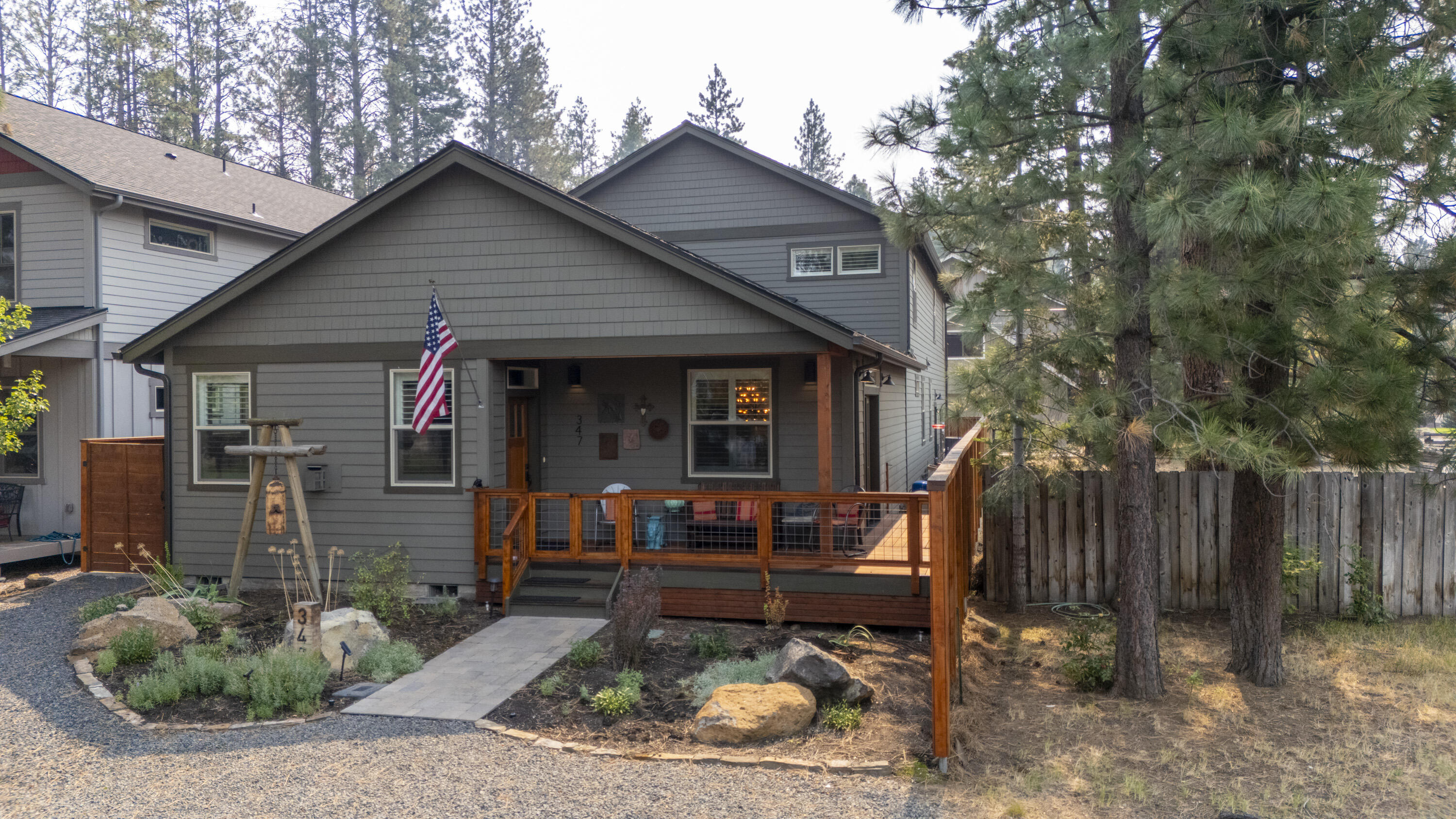 PRICE IMPROVEMENT! Welcome To This Quality Built Custom Home That Includes Its Own Attached ADU with Full Living Accommodations. The main level features a Primary Bedroom & suite with an additional second bedroom and a full bathroom, full laundry room, dining area and a family room with a stone gas fireplace. The kitchen was tastefully designed to accompany large groups & offers a large Quartz island and sitting area, Quartz countertops and a generous amount of room to entertain family and friends throughout the year. Off the kitchen you will encounter your own spacious and private covered patio with plenty of room to extend your friends & family during Holidays and family gatherings.  The upper level offers a full size bathroom, bedroom and a large bonus room for hobbies or entertaining and has access to its own private deck.  The ADU has its own private access off the end of the home and shares the driveway.  The wall between the upper bonus room & ADU has added sound proof material
