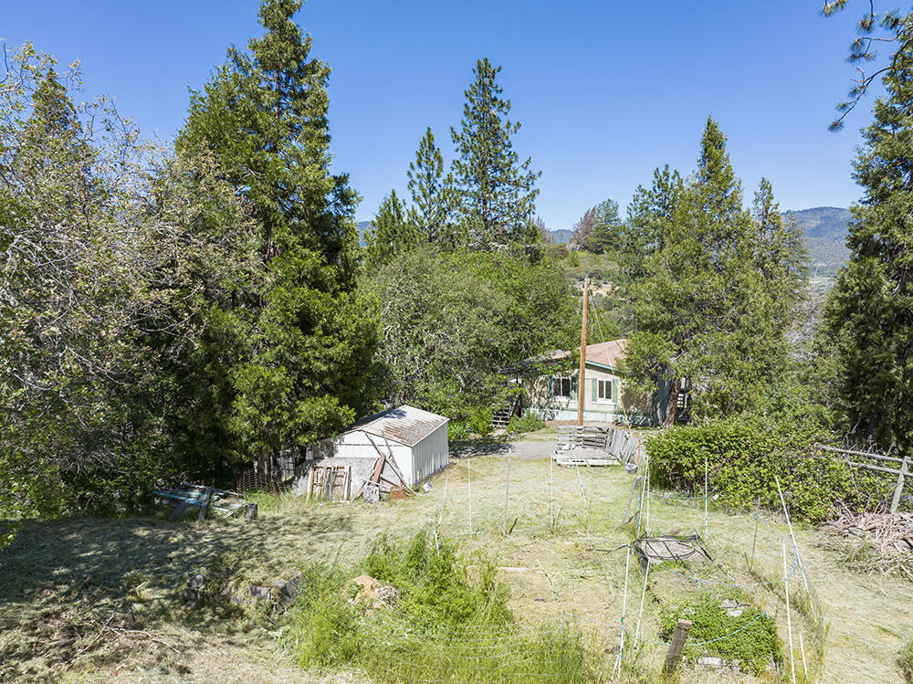 Enjoy Privacy & Stunning Views from this Lovely Property, offering a 3 Bed 2 Bath Home plus Outbuildings on 7.11 Acres of Peace & Quiet in the Applegate Valley! The Home is a Financeable Manufactured Home that is need of some work, but is absolutely livable! The Home offers a Split-Bedroom Floorpan & a Bright Open Interior. Enjoy Outdoor Living from both the Front & Rear Decks. Property is Rolling to Sloped in places, but with some Excellent Level & Useable Land, & plenty of room for Animals & Gardens. The Lower Portion of the Property features the Home & Outbuildings, plus Garden Spots & Space for Animals. The Shining Gem of this Property is the Fantastic Upper Knoll, with Level & Useable Land, Power & Water, Fenced Garden Space, Picnic Table, Small Outbuilding & Absolutely Incredible Views! This is the IDEAL Location for a New Home Build, or for a Yurt or Cabin or Tiny Home. It is Incredibly Quiet & Serene at the top. ALL Professional Inspections have been Performed at this Property!