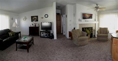 THE INSIDE STORY is the art of living. Discover this home's special features in a grand, open & spacious split floor plan with vaulted ceilings. An entertainment size living room features a wood burning fireplace to cozy up to. The kitchen, with yards of granite counters & lots of oak cabinets, has a breakfast bar as well as a dining area. The walk-in closet in the master is the size of many bedrooms! The bath features a step-in shower. Under the carport is a covered deck with mountain views. This light & bright 2006 Karsten home will change your life with style. You must get inside!