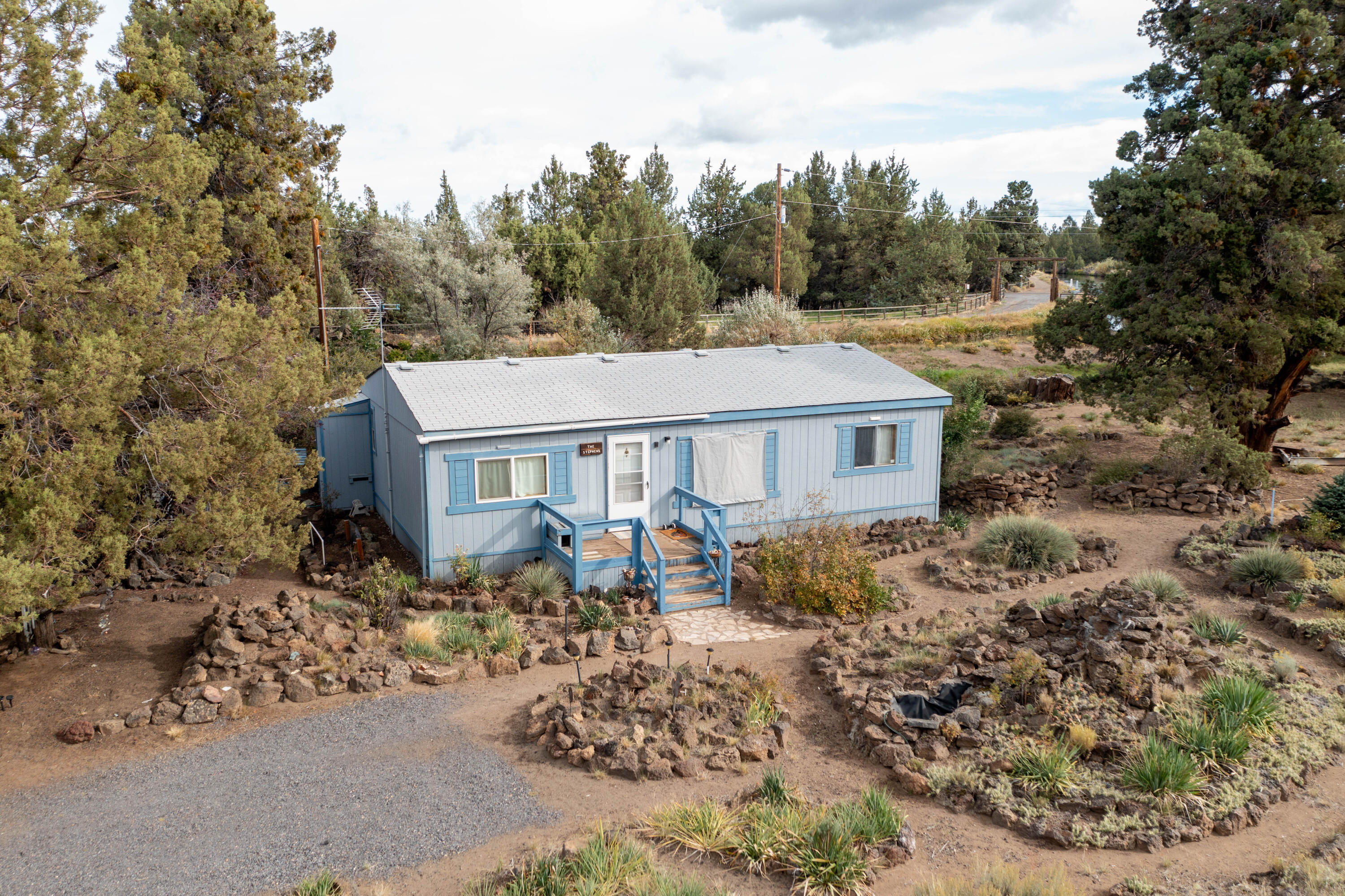 Beautiful Building Site on 11 Acres Along the Central Oregon Irrigation CanalDiscover the beauty and serenity of this private 11-acre property, perfectly positioned along the Central Oregon Irrigation Canal. With selective tree removal, you'll unlock breathtaking mountain view potential to complement the natural setting.The property is well-prepared for your future dream home with a well in place, septic installed, a cistern, and multiple outbuildings ready for a variety of uses. Garden beds are thoughtfully placed throughout the property, making it ideal for those who love to grow and create. A historical COI rock outcropping adds unique character and a touch of Central Oregon history.The existing manufactured home offers immediate living space while you plan and build your vision. Please note, the home is not financeable, but provides functionality during the transition.The real value lies in the land itself—scenic, private, and full of opportunity for your creative ideas!