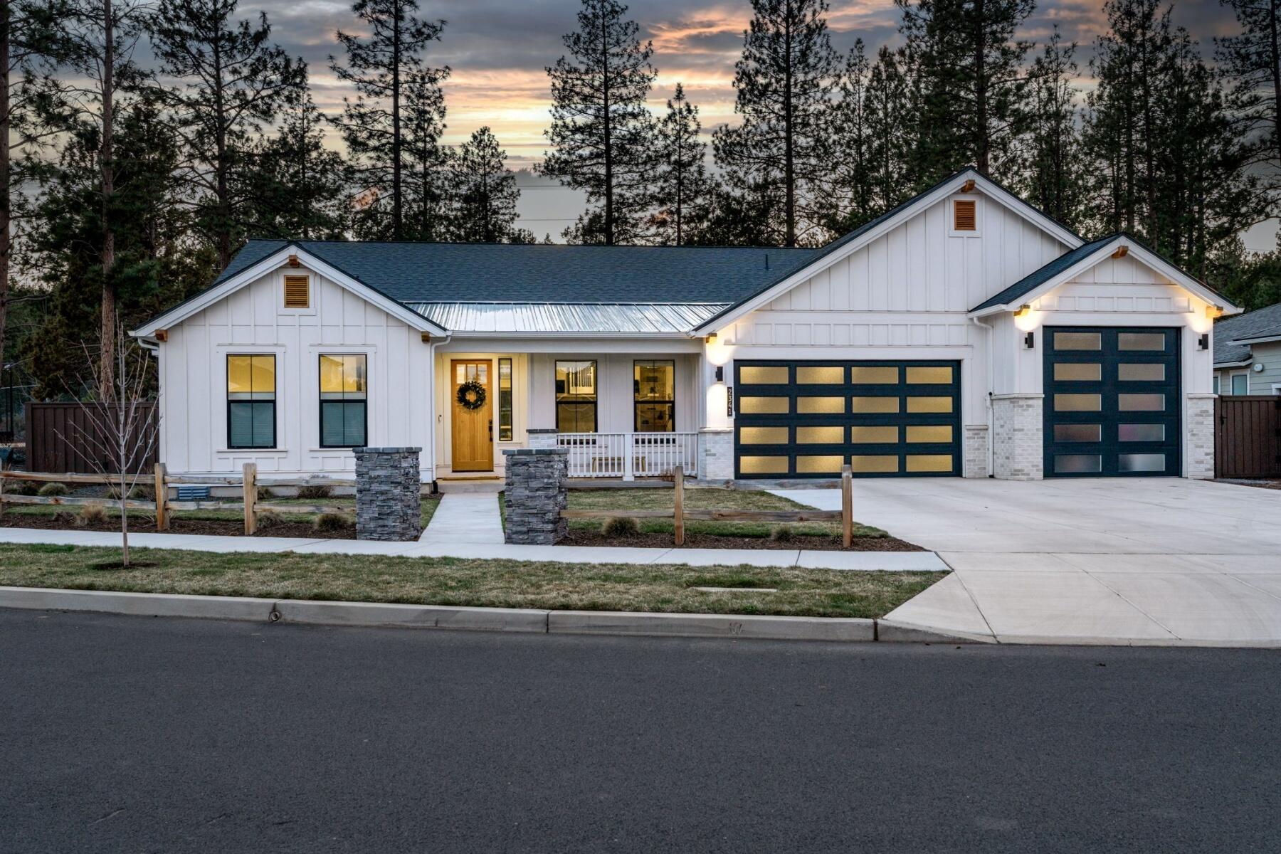 Experience modern luxury and true privacy on nearly half an acre in one of NW Bend's most sought-after neighborhoods. This stunning single-level home features soaring ceilings, an open layout, and abundant natural light. Enjoy ideal bedroom separation, a home office or den, and a spacious bonus room—perfect as a fourth bedroom or second suite with backyard access.
The chef's kitchen offers a quartz island, walk-in pantry, soft-close cabinetry, and premium appliances. Step outside to a private oasis with a covered patio, fire pit, saltwater hot tub, and lush landscaping reminiscent of Shevlin Park.
An oversized three-car garage with epoxy floors, RV parking, smart home features, and refined finishes throughout complete this exceptional Westside retreat—just minutes from trails, parks, and dining.