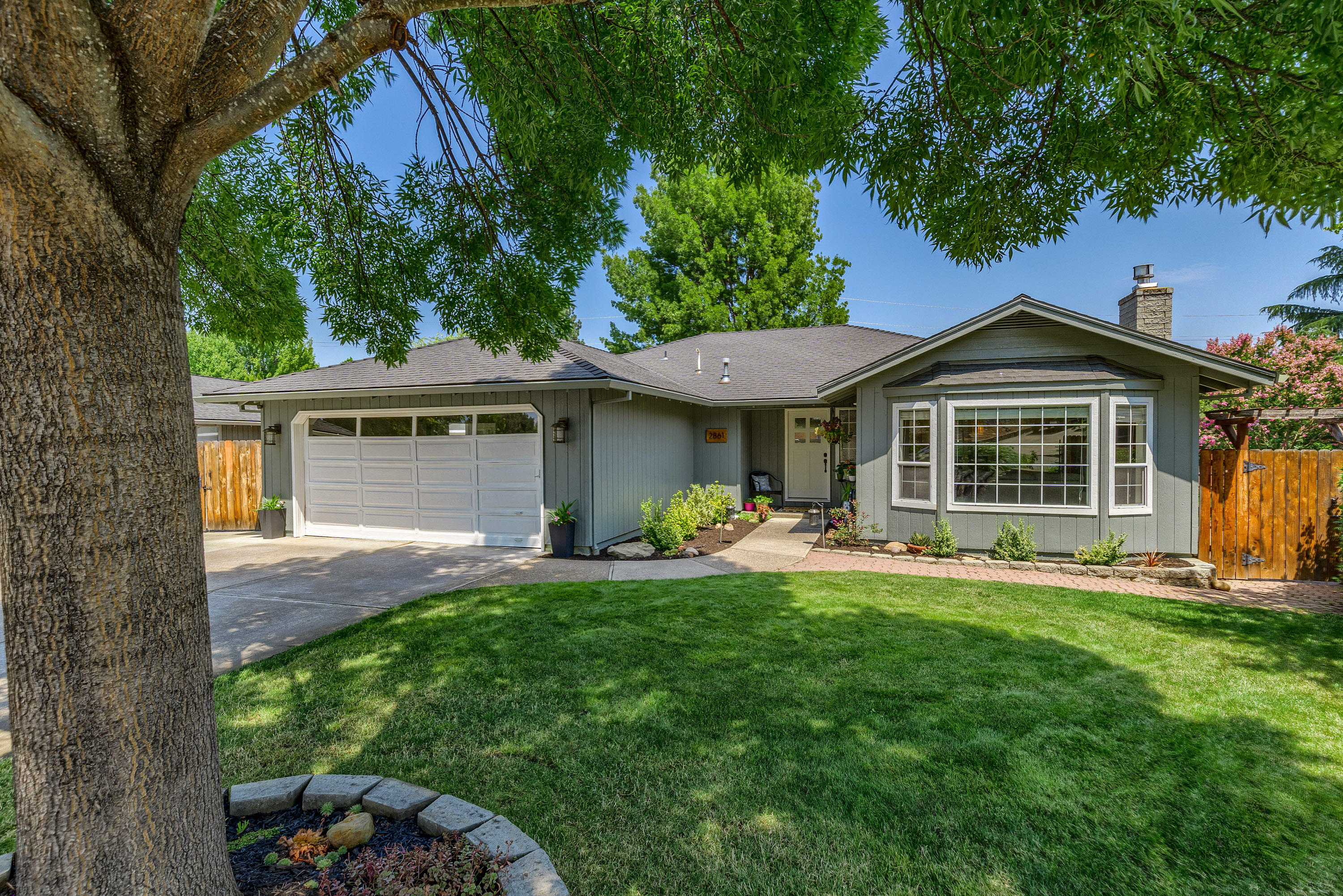 Immaculate single-level, Good Sense energy efficient home lovingly updated! Max curb appeal too! Light & bright interior w/fresh paint & updated light fixtures. Laminate flooring in main areas. French doors to vaulted living room w/bay window & gas fireplace. Sliding French doors to formal dining room. Kitchen offers granite counters, dishwasher, smooth cooktop range/oven and microwave hood. Bay window in dining nook. Family room off nook & kitchen. Spacious master suite has transom window, ceiling fan, slider to deck, walk-in closet & updated bath. Skylight in updated guest bath. Indoor laundry room has extra cabinet storage. Nest climate control system. Large, fenced back yard w/Trex decking, brick patio, hot tub pad w/220w power, trellis & lawn area.  Refreshed landscaping front & back includes in-ground sprinkler system. In addition to the attached 2-car finished garage there is a separate shop w/garage door & opener plus great RV parking!  Short distance to schools.