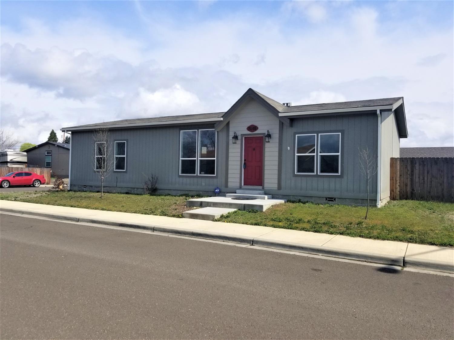 Nice home in a great neighborhood! Large lot with a 2 car detached garage, this manufactured home has received new interior paint and carpeting. The open and split floor plan. The master suite includes a walk-in closet and the bathroom is spacious with two sinks. Move in ready!