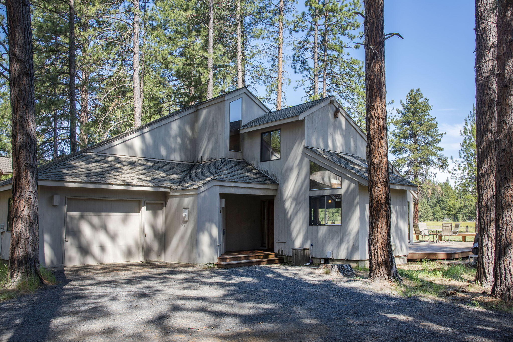 Welcome to your dream retreat at Black Butte Ranch! This stunning 4-bedroom, 2-bath home boasts 2,001 sq. ft. on a spacious .45-acre lot with breathtaking views of the meadow and Black Butte. Enjoy easy access to the Glaze Meadow Recreation Center, tennis, and pickleball courts. The living room features a vaulted wood-paneled ceiling and a grand stone fireplace, seamlessly blending with the dining area. Two spacious downstairs bedrooms share a unique Jack and Jill bathroom with a soaking tub. Upstairs, find a versatile loft, bathroom and two additional bedrooms, ideal for family gatherings, this home sleeps 9 comfortably. The laundry room adds convenience, and the extra-long garage is perfect for your outdoor gear. Embrace Black Butte Ranch amenities, which includes championship golf, scenic restaurants, trails,  nearby skiing and fly fishing. Explore the charming town of Sisters for even more dining and shopping options. Easy access via Redmond airport makes it the perfect getaway!