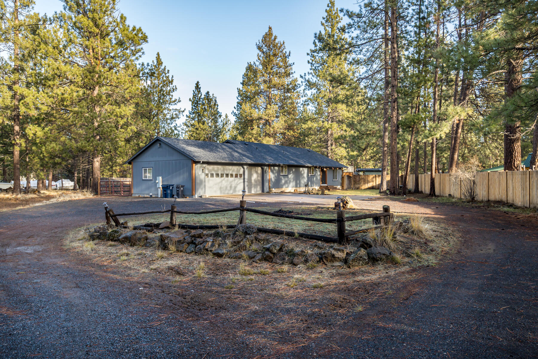 Set on a spacious .91-acre lot in Deschutes River Woods, this thoughtfully designed single-level home offers comfort, privacy, and functionality. The desirable split-bedroom floor plan provides excellent separation between the primary suite and additional bedrooms. An open-concept living space showcases vaulted ceilings and a new wood stove, creating a warm and inviting atmosphere that flows seamlessly into the oversized living room and large kitchen with island—ideal for gathering and entertaining. Additional highlights include a generous laundry/mud room, attached 3-car garage with workbench, and a large turnaround driveway. The fully fenced backyard features covered RV parking, offering flexibility for storage and recreation. Fresh interior paint and brand-new carpet make this home truly move-in ready. A rare opportunity on a nearly one-acre lot—schedule your private showing today.
