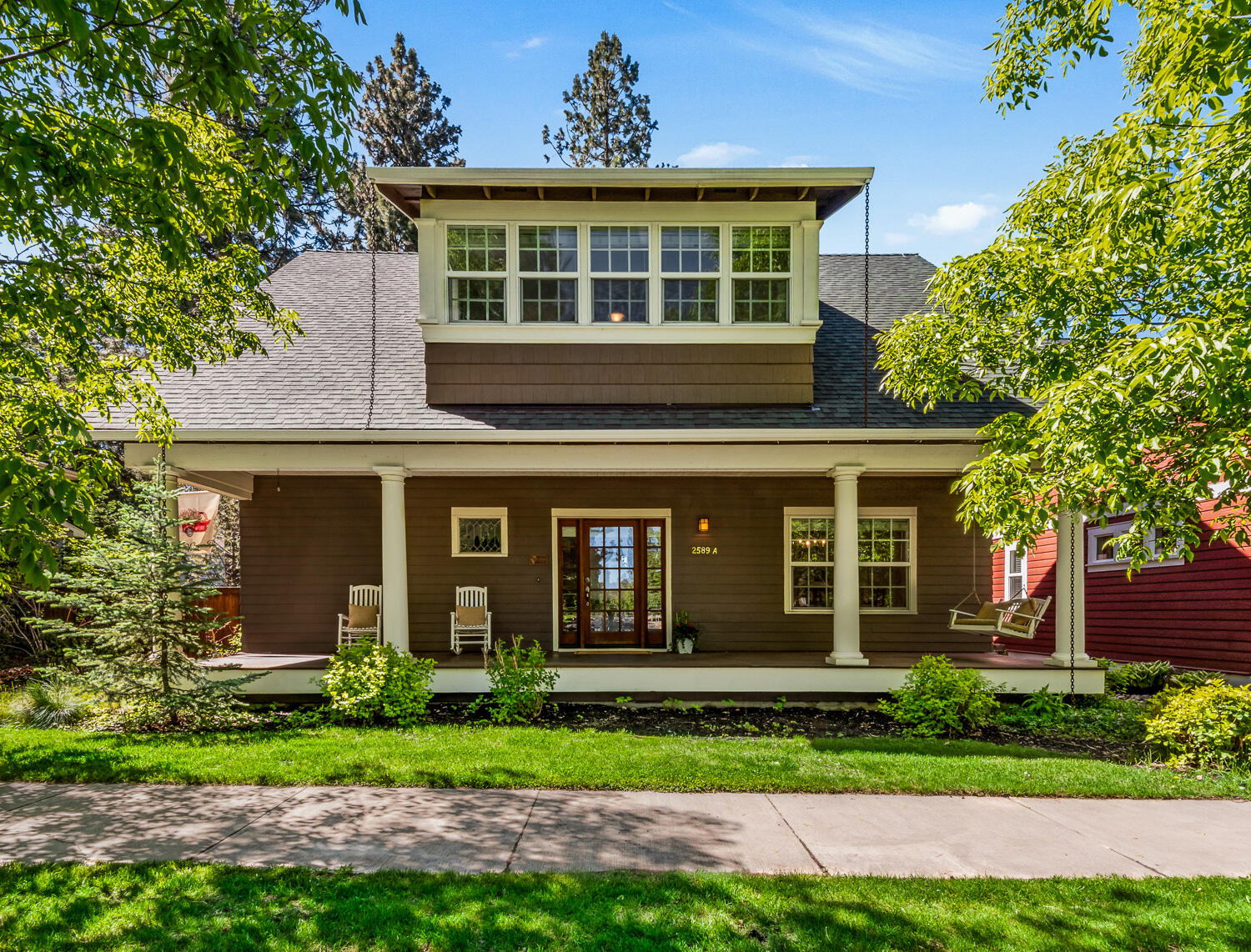 Live in the heart of Northwest Crossing—steps from Discovery Park, the Saturday Market, RBC Steakhouse and Sparrow Bakery. This 2,038 sq ft home plus the 550 sq ft ADU offers 3 beds/2.5 baths in the main house with craftsman touches, hardwood, slate and cork floors, updated kitchen, walk-in pantry and a large soaking tub in the primary suite. Guest bedrooms boast bonus storage, and upstairs a loft with a full wall of sash windows overlooks mature trees with peek-a-boo mountain views and a huge storage/play area. The ADU features its own entrance, 1 bed/1 bath, full kitchen, laundry, gas fireplace, mini-split AC and extra storage under the stairwell. Outside enjoy a huge front porch, flagstone patio, gas fire pit and landscaping. Includes a 2-car garage plus three off-alley parking spaces. Near parks, top schools and the Grove—rare versatility in one of Bend's most coveted neighborhoods.