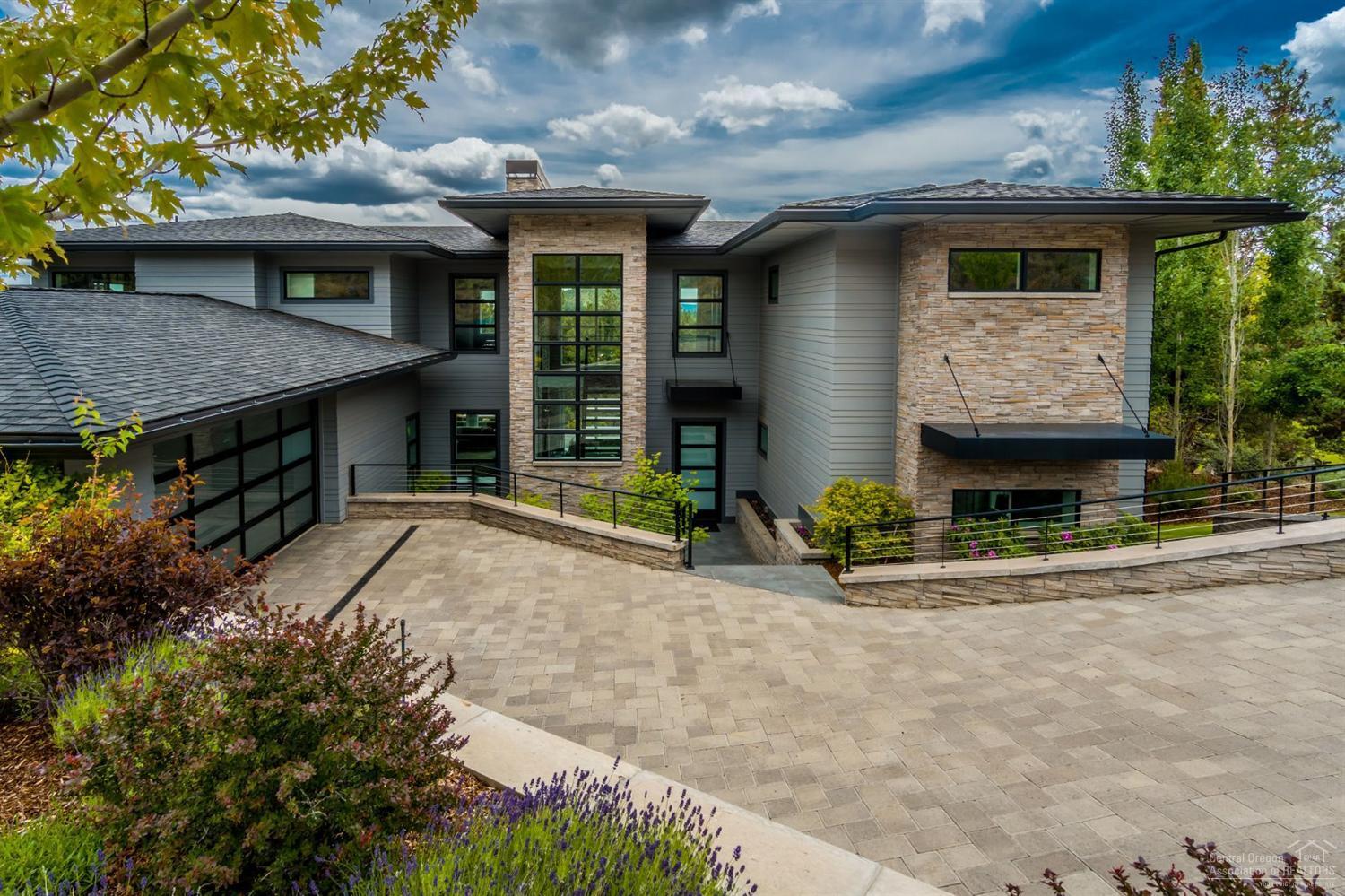 Fabulous Northwest contemporary one owner home with mountain, golf course, terrain and city light views on a large parcel in Rivers Edge. Extraordinary craftsmanship & designed to ensure almost every room has a view. Dramatic entry, soaring ceilings, floor to ceiling fireplace and windows, open floor plan, both casual and formal living areas, gourmet kitchen, 4 bedrooms, two master suites, office, bonus room, large private deck w/hot tub. Attention to detail is evident in all aspects of this home.