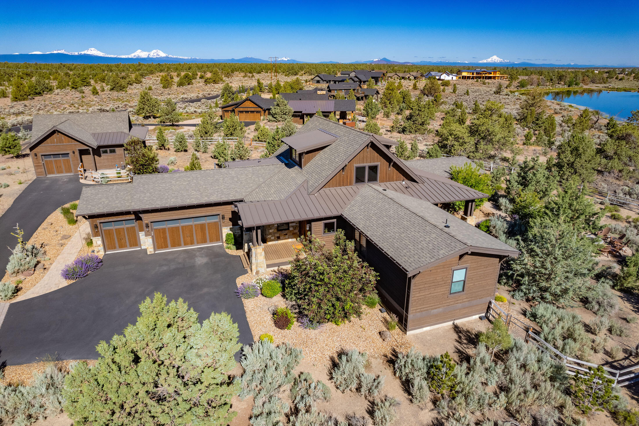 This stunning Brasada Ranch home sits on nearly two acres—one of the largest lots in
the community—provides ample space and privacy while offering convenient access to
resort amenities.
Enjoy direct access to Shumway Lake, a fully fenced yard, and heated indoor/outdoor
kennels for pets. The detached 1,100 sq ft shop provides ample storage, with space for
a casita or RV garage.
Inside, French oak floors, knotty alder vaulted ceilings, and a floor-to-ceiling stone
fireplace set the tone. The chef's kitchen features leathered granite counters, hickory
custom cabinets, a Wolf cooktop, and stainless steel appliances. The primary suite
boasts deck access, a custom barn door, a tiled shower, quartz counters, and a walk-in
closet.
Relax outdoors in a landscaped oasis with covered decks, a fire pit, and a water feature.
A three-car garage adds convenience. Enjoy world-class Brasada Ranch amenities,
including golf, pools, spa, and dining.