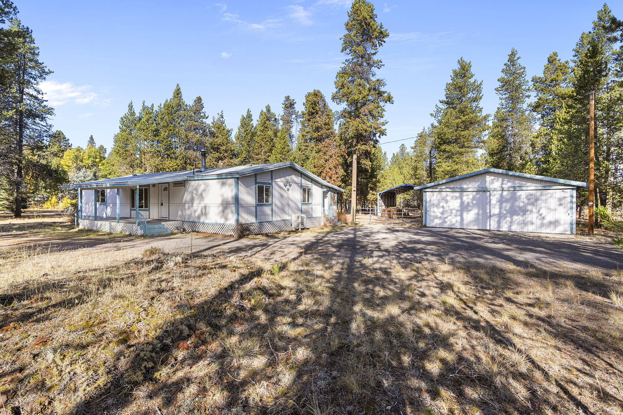 Tree-lined 0.99-acre corner lot offers space, charm, and potential-with dual access from Day Road and Falcon Lane and a circular gravel drivewayfor easy access on those snow days. Outbuilding includes a double detached garage with an attached shed, and a large RV carport with power. The fully fenced backyard provides privacy and space for pets. A covered back porch off the laundry room adds extra storage. Inside some updates have been made; enjoy vinyl windows, vaulted ceilings, and a cozy wood stove. Features include fiber internet, a metal roof, and some newer flooring throught. The kitchen offers a pass-through window, range/oven, refrigerator, dishwasher, dry bar, and deck access. All appliances are included. No HOA. Great for full-time living or a weekend retreat-just minutes away from Hwy 97, Mt. Bachelor, lakes, rivers, and year-round recreation.