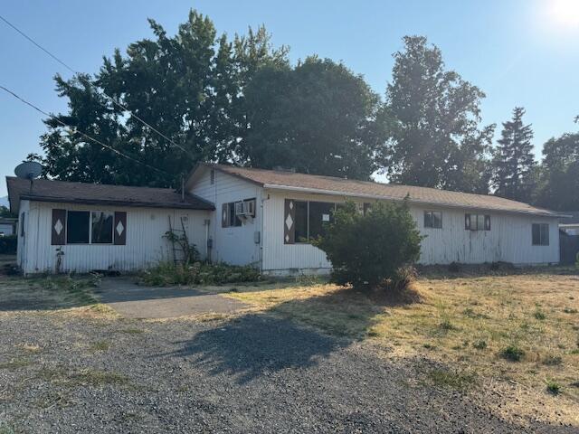 This gem offers bounds of potential. Located on a huge corner lot.   Located close to schools and shopping. This property has tons of room for parking with access from 2 streets and has a large covered deck in back. Step inside this large sq ft home that offers a bright living room, large bonus room and so much more. Come check out the immense possibilities!