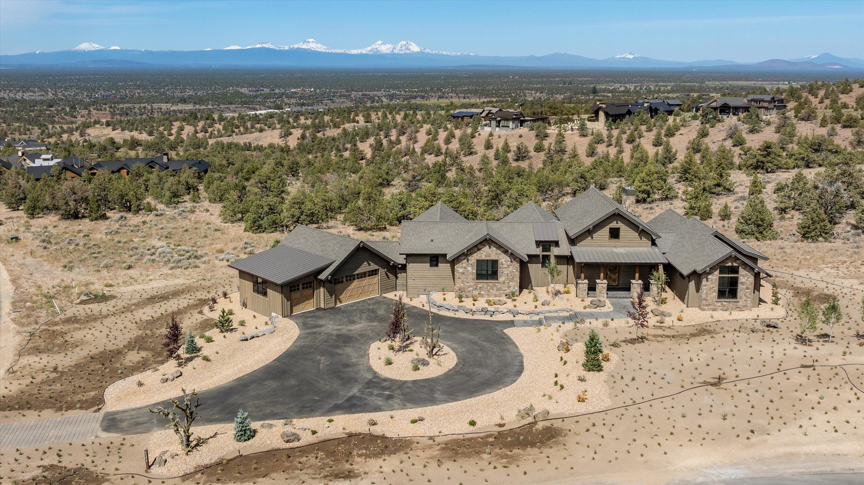 Impeccable NW Style New Construction home with breath taking views of the magnificent Cascade Mountains off of the spacious back deck. This home offers an open floor plan with hardwood floors throughout, a capacious kitchen, a pantry with an office space and custom-built ins, an open dining room, and a great room that features a solid stone fireplace that expands to the vaulted ceiling. Enter the primary suite to continue the gorgeous views and exit onto the back deck to enjoy the famous sunsets behind the Cascade Mountains. The primary bedroom also boasts of a large walk-in closet, double vanity, a soaking tub, and a floor-to-ceiling tile shower. Additionally, you will find two additional bedrooms with a full bathroom, a large laundry room, and a generous three bay garage complete the home.