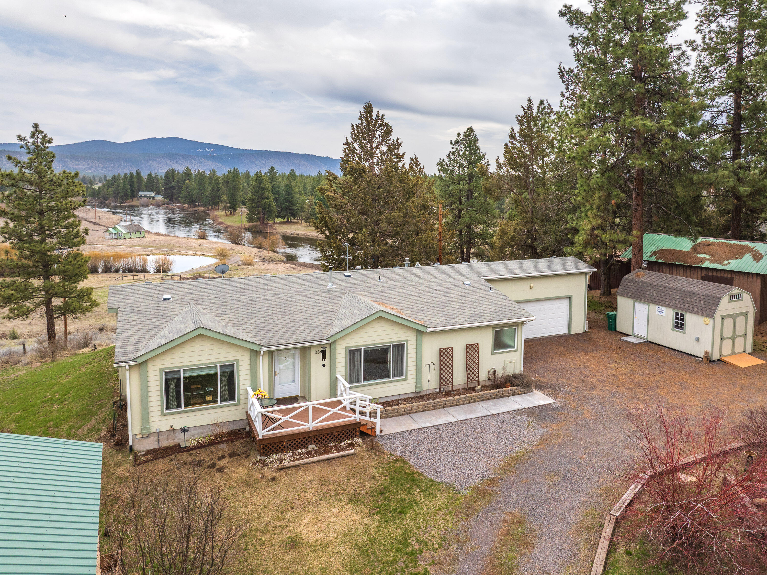 An outdoor enthusiasts dream awaits with the Williamson River, trophy fishing, right out your back door, & 30 min drive to Crater Lake National Park. Access to the river just below the property where you can launch a small boat or kayak. This spacious 4 bedroom, 2 bathroom home features a wonderful open floor plan with large windows streaming in natural light. Enjoy your coffee near the cozy pellet stove in the living room or step out onto the large back deck & take in the beautiful views! Nice primary suite with walk in closet, double sink vanity oversized shower & soaking tub. Detached 20x30 covered RV parking with electrical hookup. Plus attached 2 car garage with shelves & workbench. Additional outdoor shed with power, loft space & nice built-ins. Don't miss the garden area with raised beds & green house. This home feels brand new and pride of ownership shines throughout! Call to schedule your showing today!
