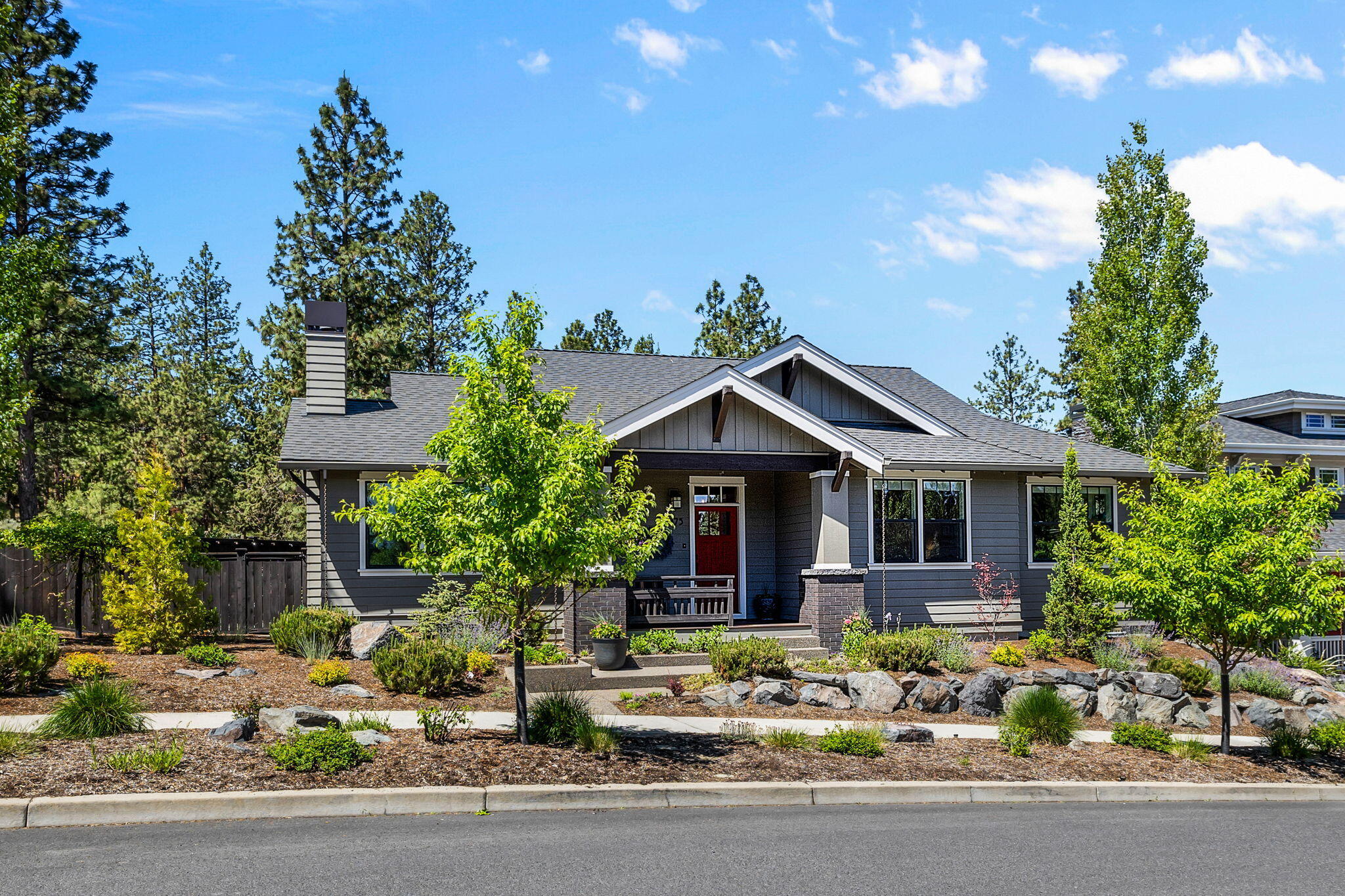 Charming and cheery single level Craftsman in the desirable Northwest Crossing neighborhood. Light & bright with sun streaming in all day long. The open concept floor plan greets you with wood floors, vaulted ceilings, built-ins around the gas fireplace & warm finishes throughout. Chef's kitchen is complete with stainless steel appliances, large quartz island and an abundance of cabinets. Luxurious primary suite with heated floors in bathroom & walk-in closet offers a private retreat-nicely separated from 2 additional bedrooms. In the back, an inviting fenced garden patio awaits you, perfect for that morning coffee or get-togethers with family and friends. Oversized 2 car garage with alley access & lots of room for all your toys. Beautifully landscaped on a low maintenance corner lot. In a great Westside location with easy access to downtown, the active West Bend Trail right outside your door and all that we love about living in Bend, OR!