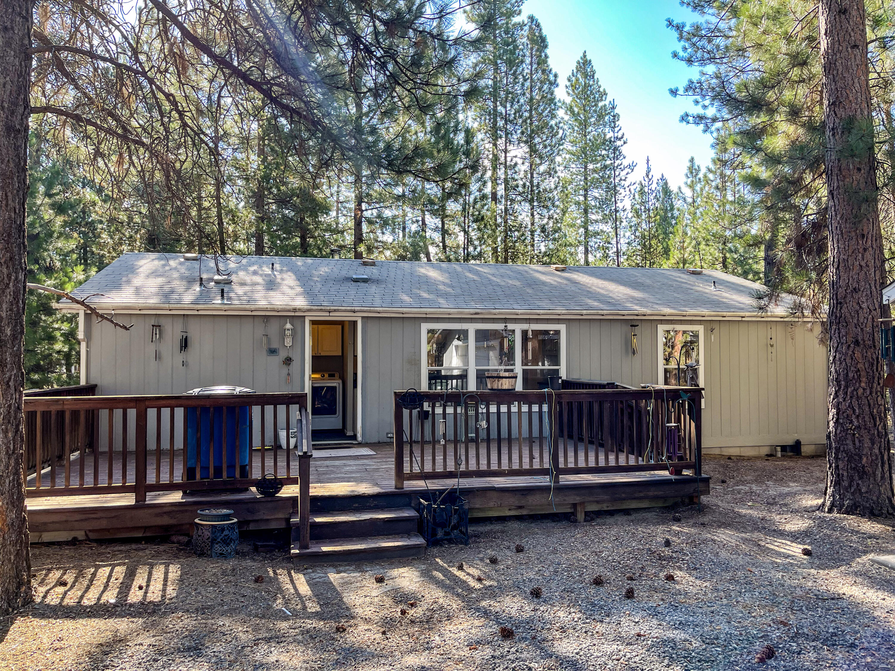 Experience peace and tranquility in Central Oregon! This  1.75-acre property, located in the desirabale Ponderosa Pines Subdivision, features a  3-bedroom, 2-bath home, a spacious detached 2-car garage, and a 1,440 sq ft shop which has a partial loft, a workbench and room to park rv or boat. The back deck offers a wonderful view of the birds and deer that frequently visit the area.
 Once inside, you'll find an open floor plan filled with natural light, thanks to the abundance of windows and high ceilings that seamlessly bring the outdoors in. The primary bathroom has  recently been updated and includes a lovely soaking tub and a separate shower. 
Many lakes, rivers and mountains are all nearby, providing easy access to enjoy the outdoor wonderland  that  Central Oregon offers. La Pine and Sunriver are minutes away for all your medical, banking, shopping needs. Come see this property and make it your home!