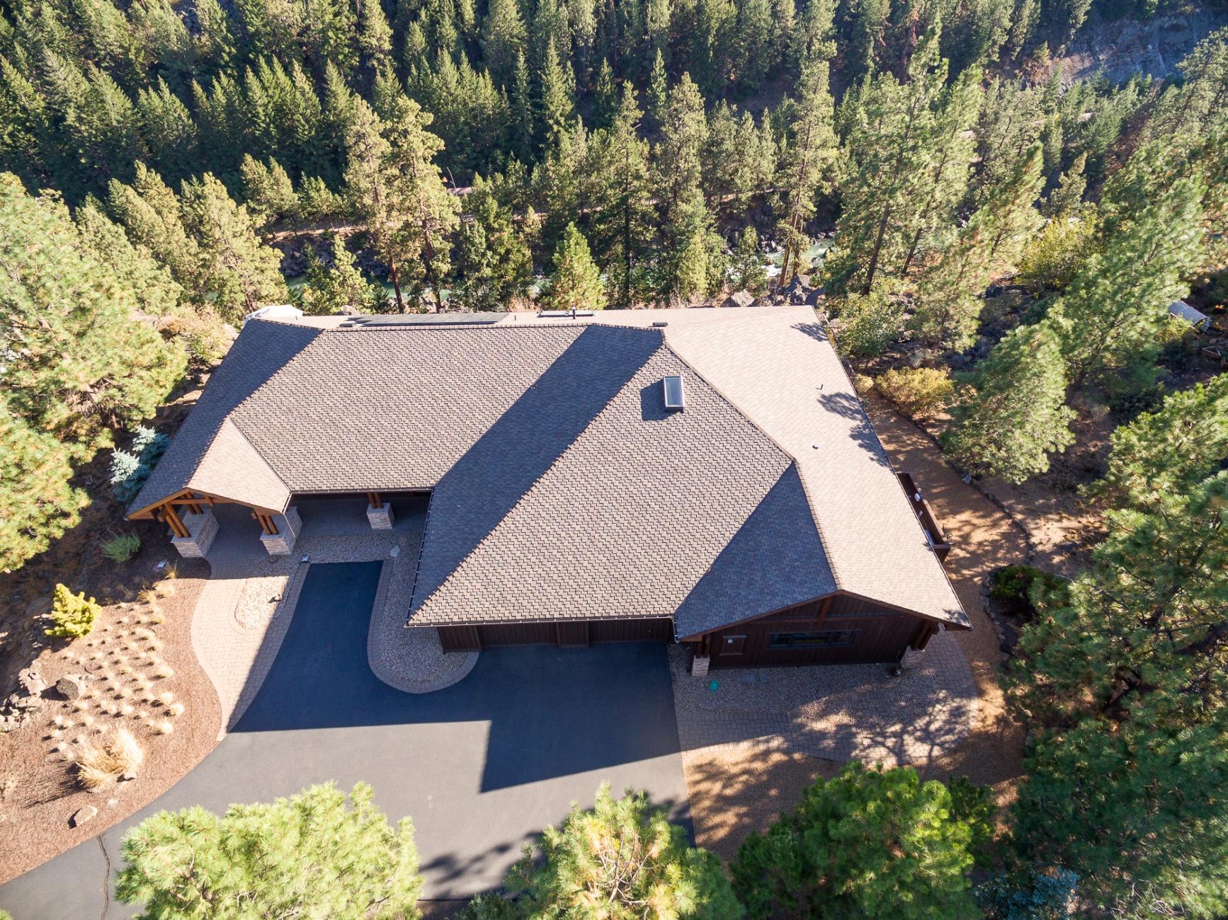 Life on the Deschutes River canyon is indescribably beautiful and soul fulfilling. Watch ospreys fishing, bald eagles soaring and amazing wildlife as you look down on the river from the expansive deck. This stunning contemporary home is situated in the coveted Sunrise Village neighborhood. Featuring single level living with two master suites, upstairs bonus room, custom mill work, tile floors, windows to soak in the natural light throughout, custom cabinetry, stainless steel appliances and more. With 4 bedrooms, 3 baths, and bonus the property offers function for many types of households. Plenty of storage with 2 car garage and a large mud/utility room and butler pantry. A/C, radiant flooring, forced air, and solar power are a few additional amenities. Outside spaces include an expansive outdoor deck to relax and soak in the sounds of the Deschutes and unobstructed views. Easy access to to river trail, golf courses, mountain biking and just 20 minutes from Mt. Bachelor. One of a kind!