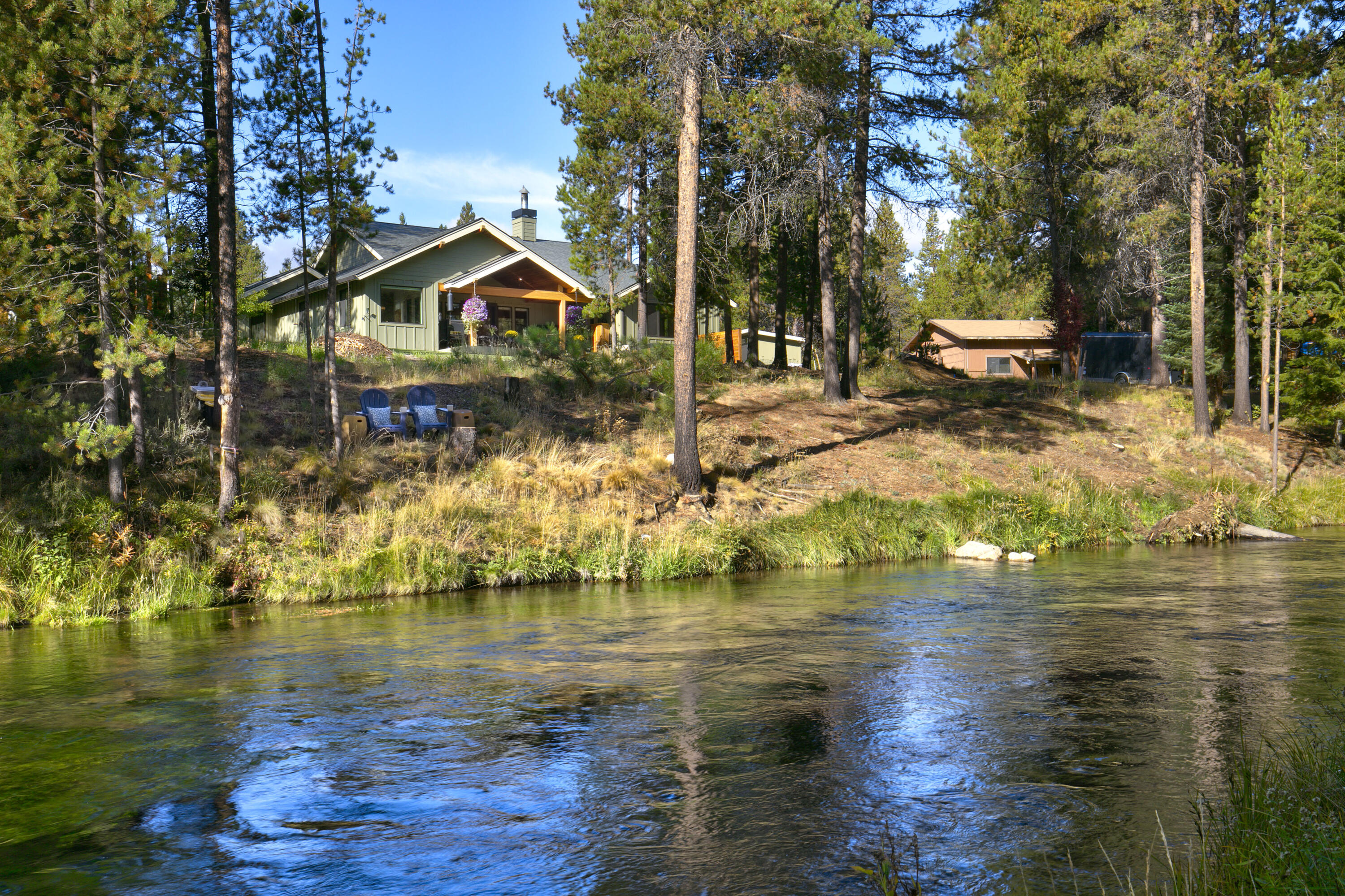 Nestled amongst towering pine trees, this custom built home provides the most remarkable opportunity to live on the picturesque Fall River best known for its beautiful, clear spring-fed stream and world-class fly fishing. Nature's paradise is quite literally right outside your door! With 90 feet of private riverfront property, you can enjoy watching abundant wildlife, relax to the sounds of glistening water flowing by or even catch dinner. Enjoy uncompromising craftsmanship and finishes throughout including a gorgeous chef's kitchen with custom cabinetry, high end stainless steel appliances, Thermador 6 burner stove, Quartz countertops and butler pantry. Three full suites. The indoor and outdoor living spaces flow seamlessly together offering a covered patio with propane heat and luxurious hot tub overlooking the river. Bonus 30 x 50 heated and insulated shop with 15 foot ceiling and full bath. This is truly a once in a lifetime property with the very best Central Oregon has to offer.
