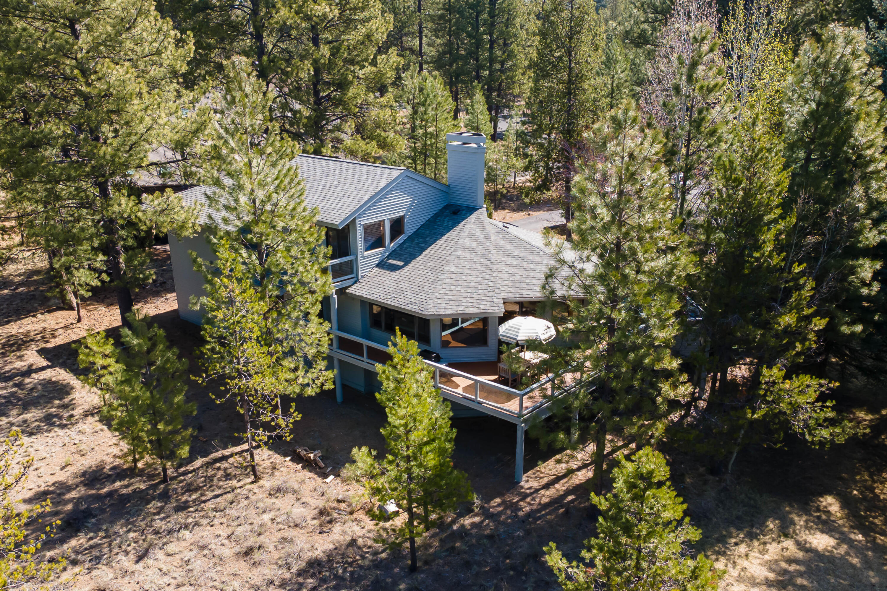 Classic Sunriver retreat with room for all! This charming home situated in the heart of the resort, steps from the Deschutes River, features 6 bedrooms PLUS a family room with great separation of space for larger gatherings. The generous kitchen boasts granite countertops, a gas cooktop & breakfast banquette. Cozy up next to the fireplace in the living room, or step out onto the deck with meadow/tree views to dine outdoors or stargaze from the hot tub! 1 Jr. suite bed/bath round out this main level; head up a 1/2 flight to 2 more guest rooms, shared bath & large utility room, or on to the top level to find a light-filled primary suite with private bath, balcony, & walk-in closet. Downstairs on the ground level are the 5th bedroom & 6th triple-bunk room, full bath & spacious family room - perfect for movie & game nights! The oversized 2 car garage provides ample room for your toys, whether you intend to keep to yourself or generate short term rental income.
